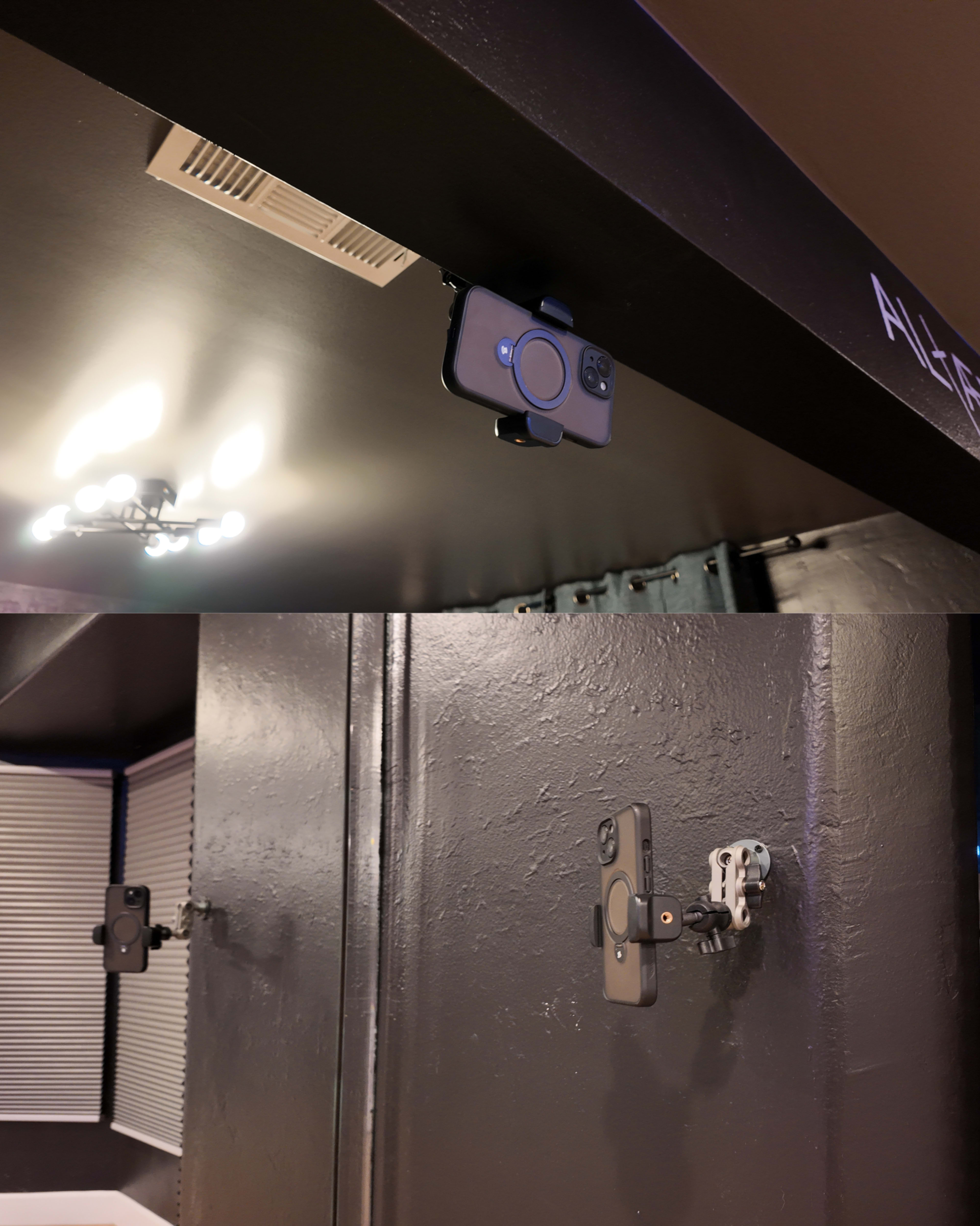 The image shows two smartphone mounts installed on a dark ceiling and wall, with one mount holding a smartphone and the other mount empty.