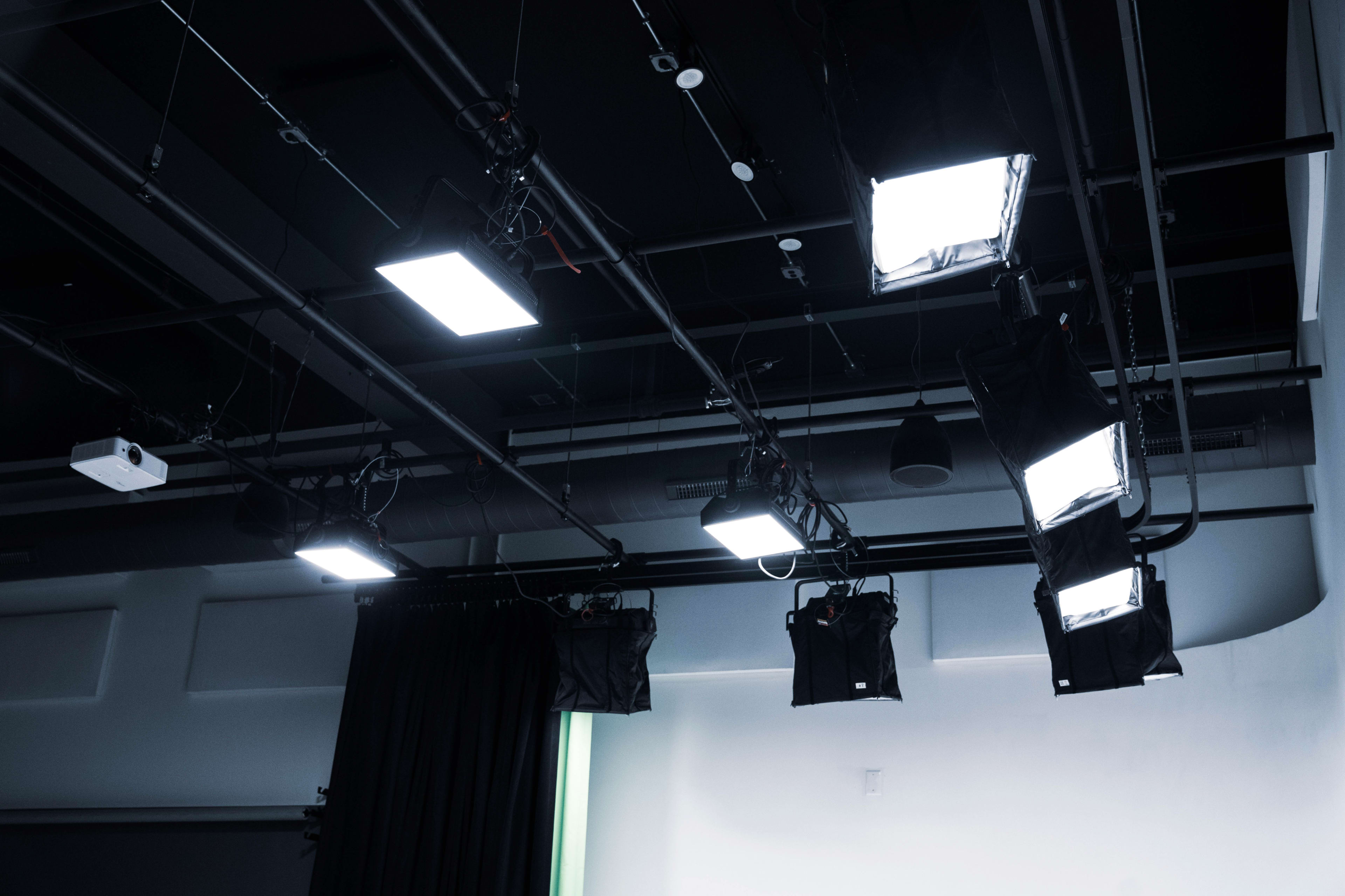 Studio lighting equipment installed on a ceiling in a production space.
