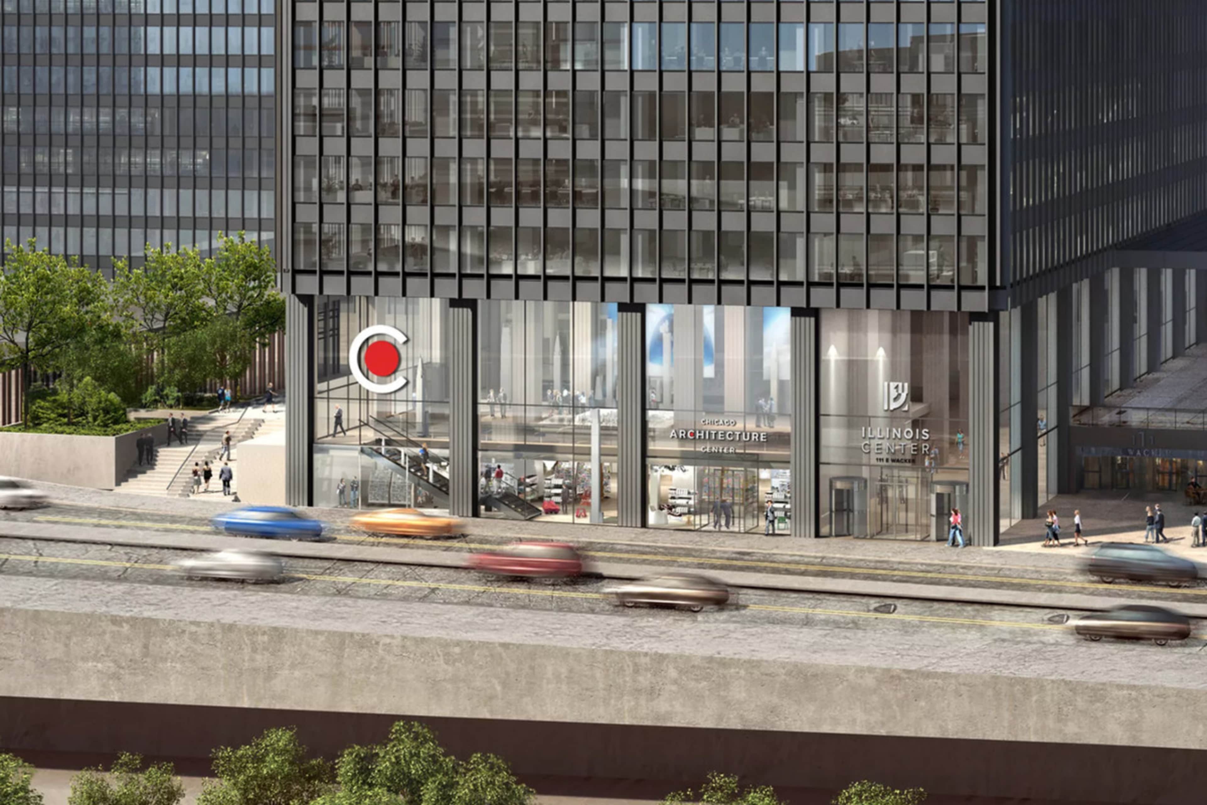 A modern building with large glass windows and a storefront displaying architectural designs adjacent to a road with moving vehicles.