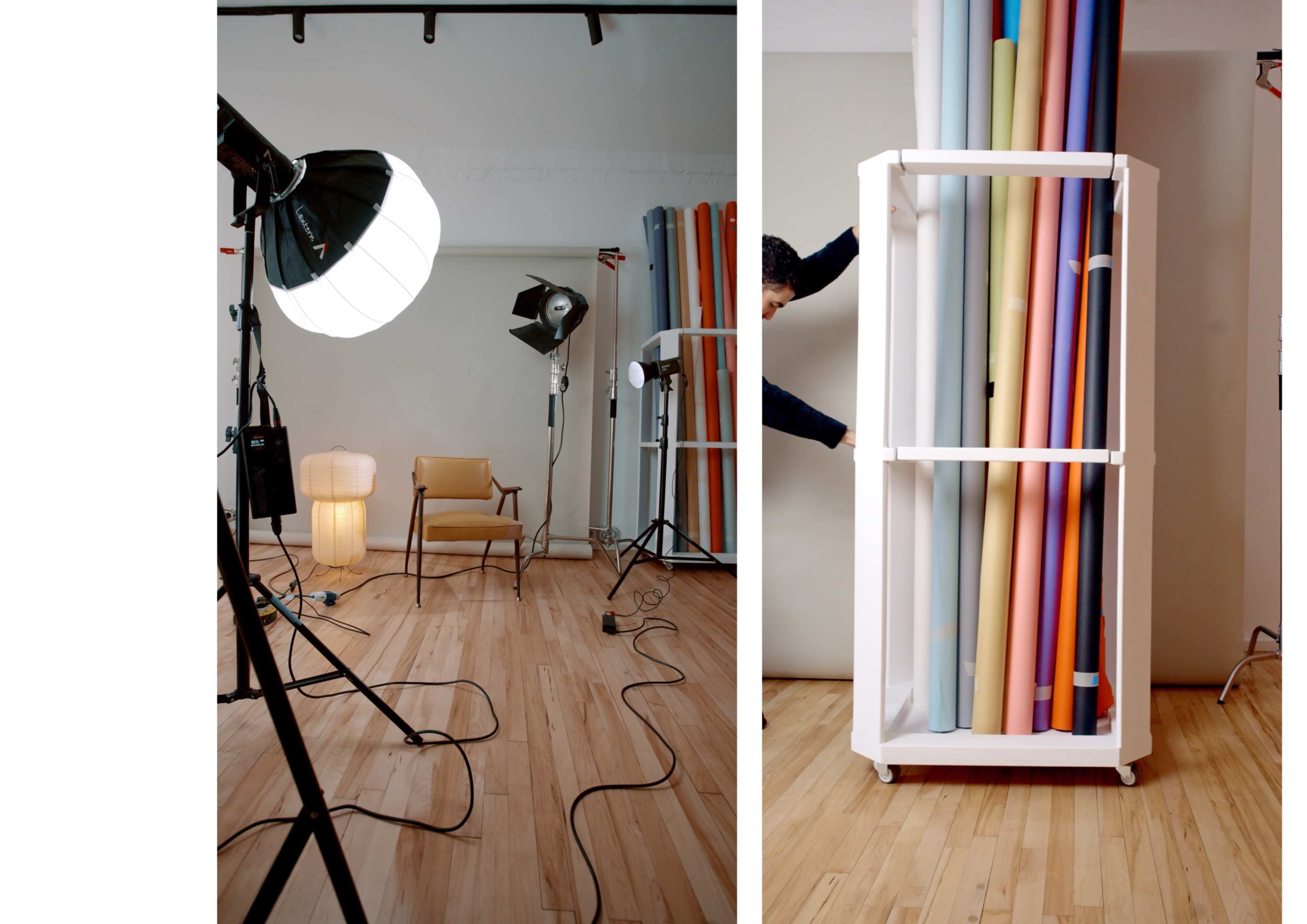 A photography studio is shown with lighting equipment, a chair, and a display of rolled backdrop papers.