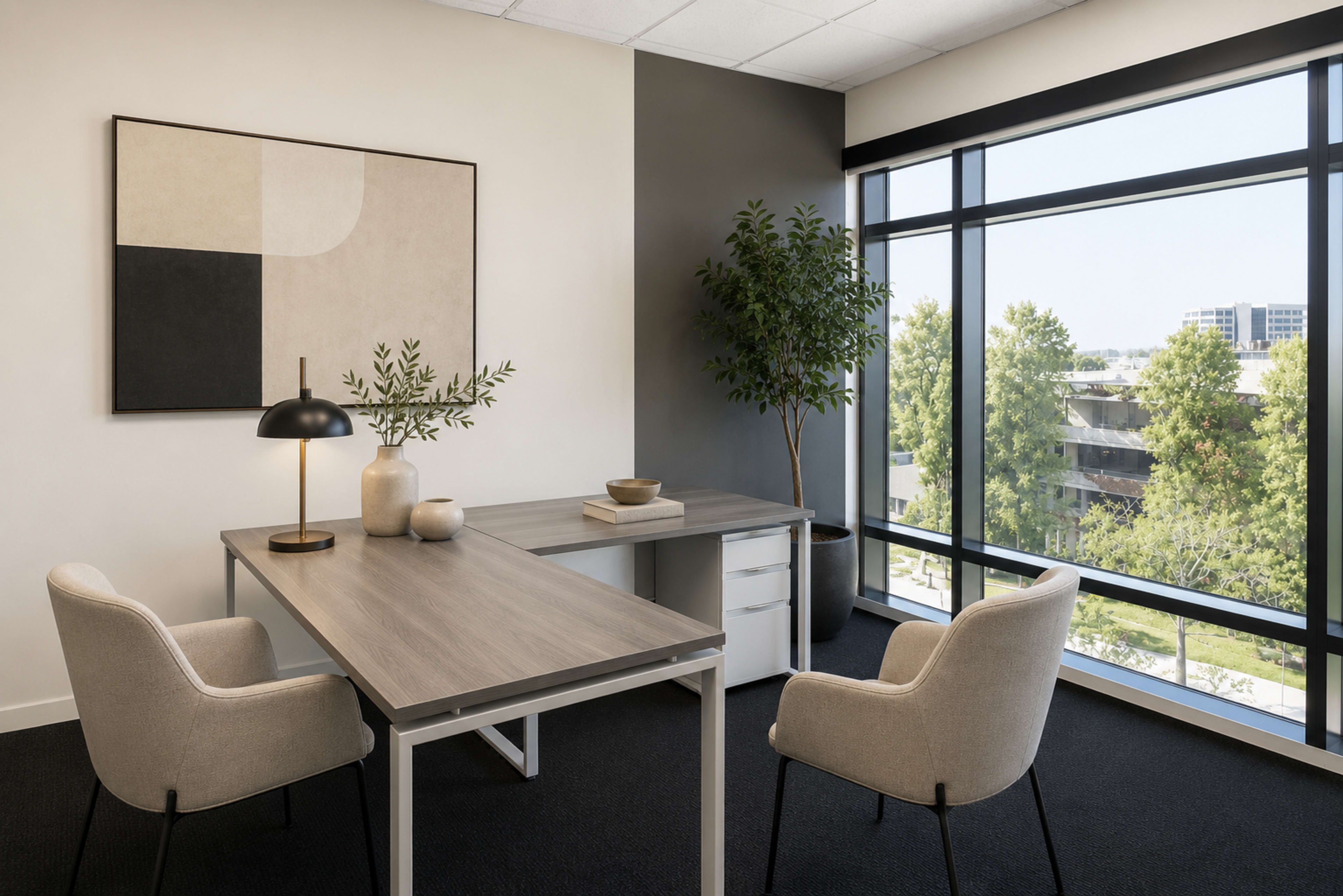 The image depicts a modern office space featuring a minimalist desk, two upholstered chairs, a lamp, and large windows overlooking a green landscape.
