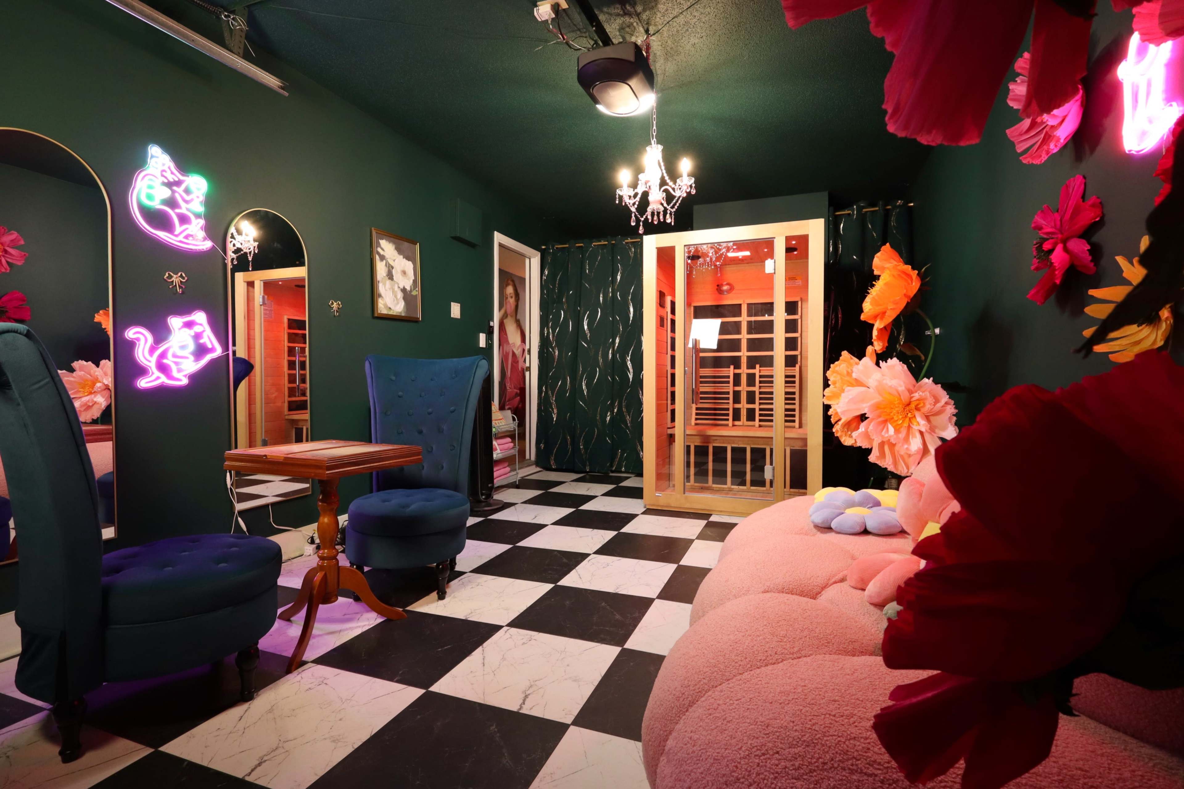 The room features green walls, a checkered floor, and various decorative elements including neon lights, floral arrangements, and vintage-style furniture.