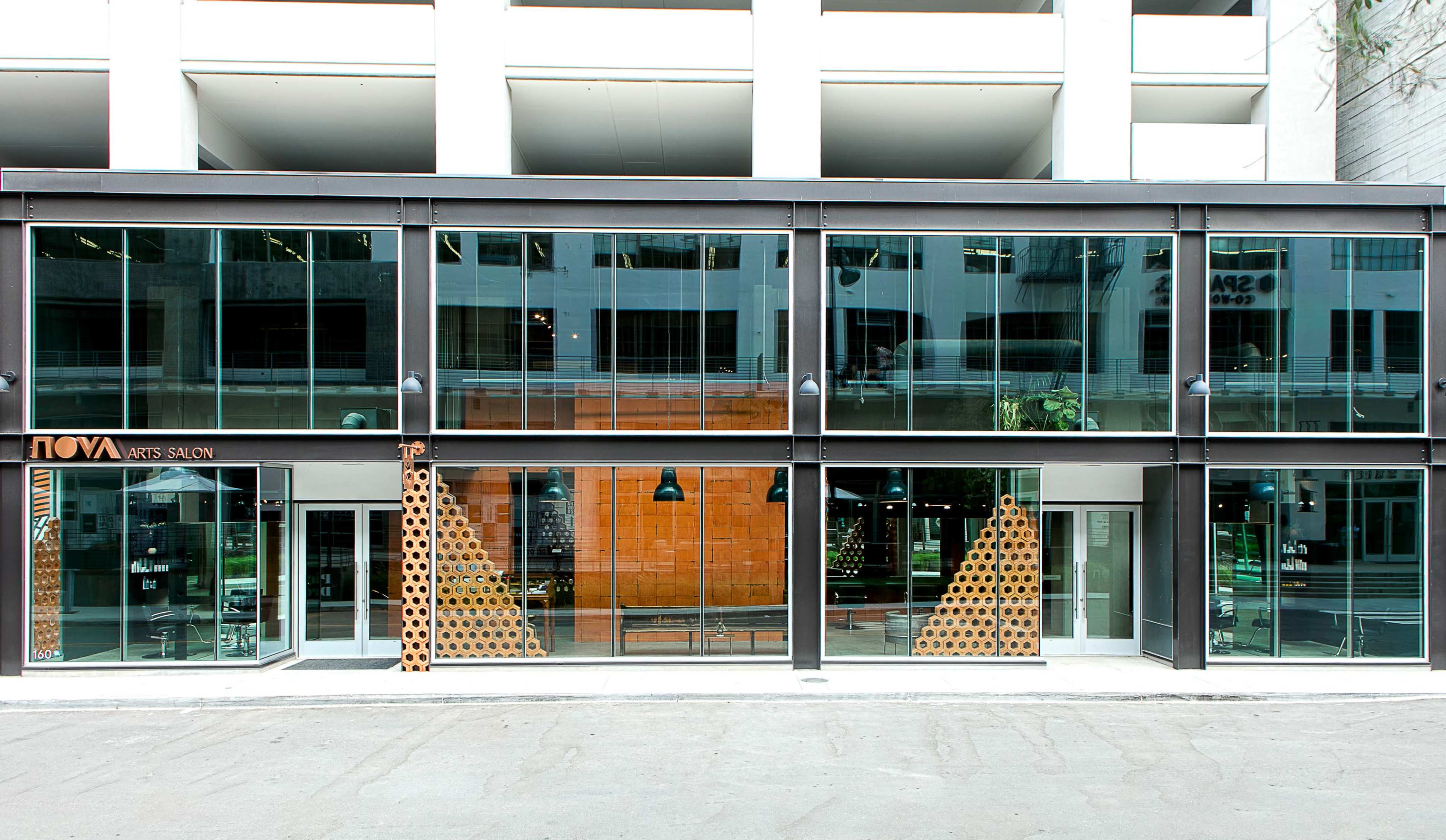 A modern storefront with large glass windows, featuring the name "NOVA ARTS SALON" prominently displayed.