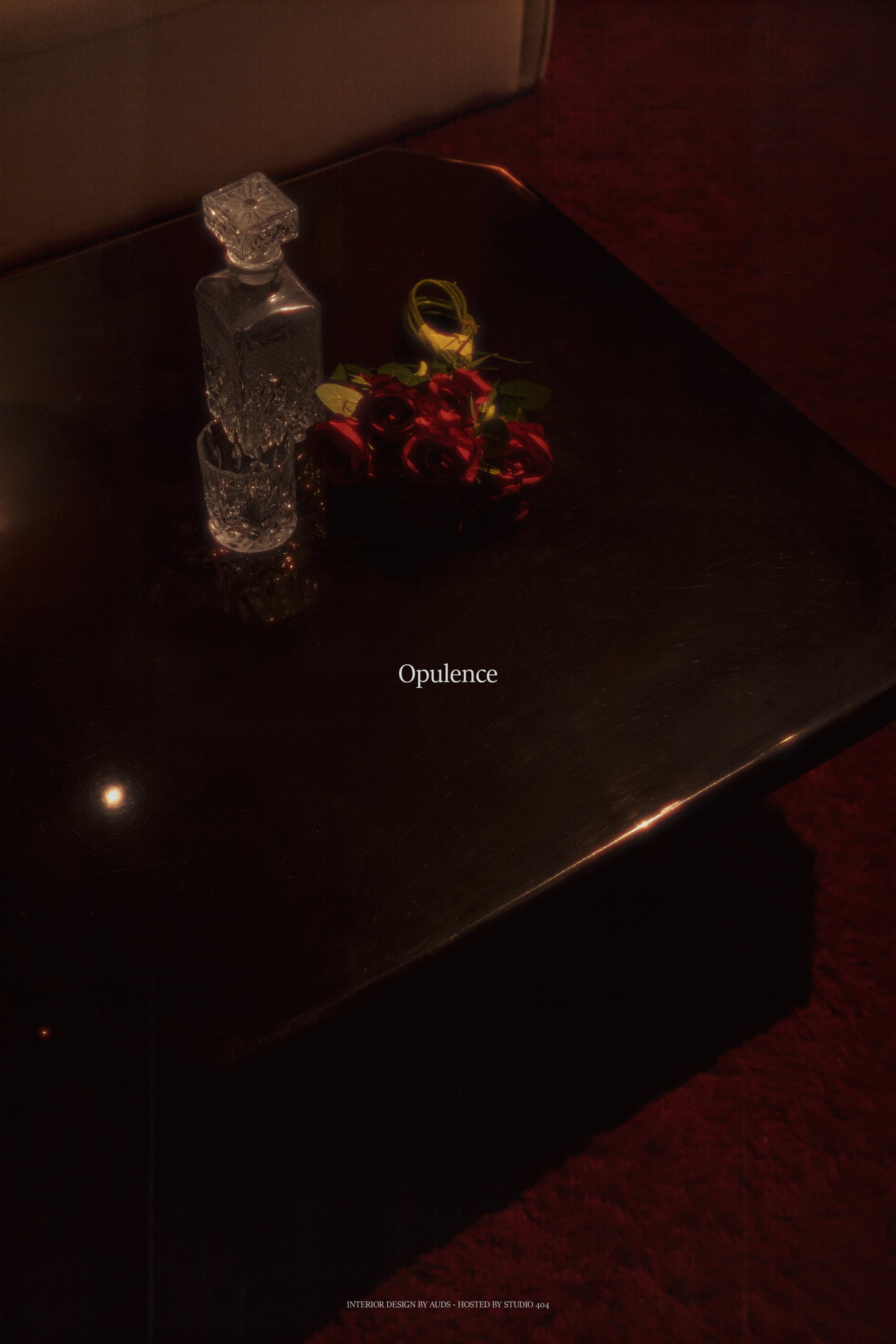 A glass decanter and a bouquet of red roses are placed on a dark, polished table.
