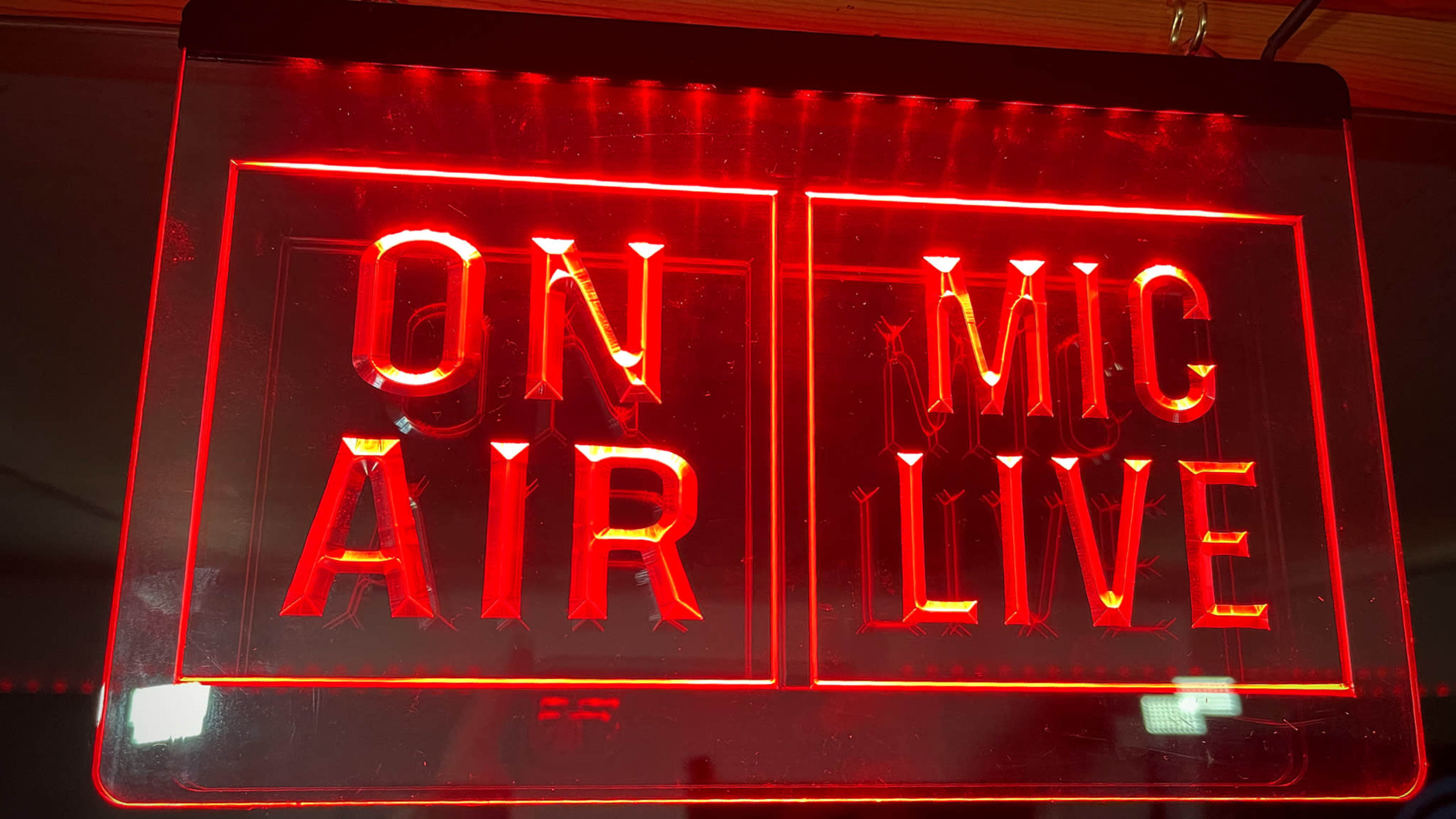 A red illuminated sign displays the words "ON AIR" and "MIC LIVE."