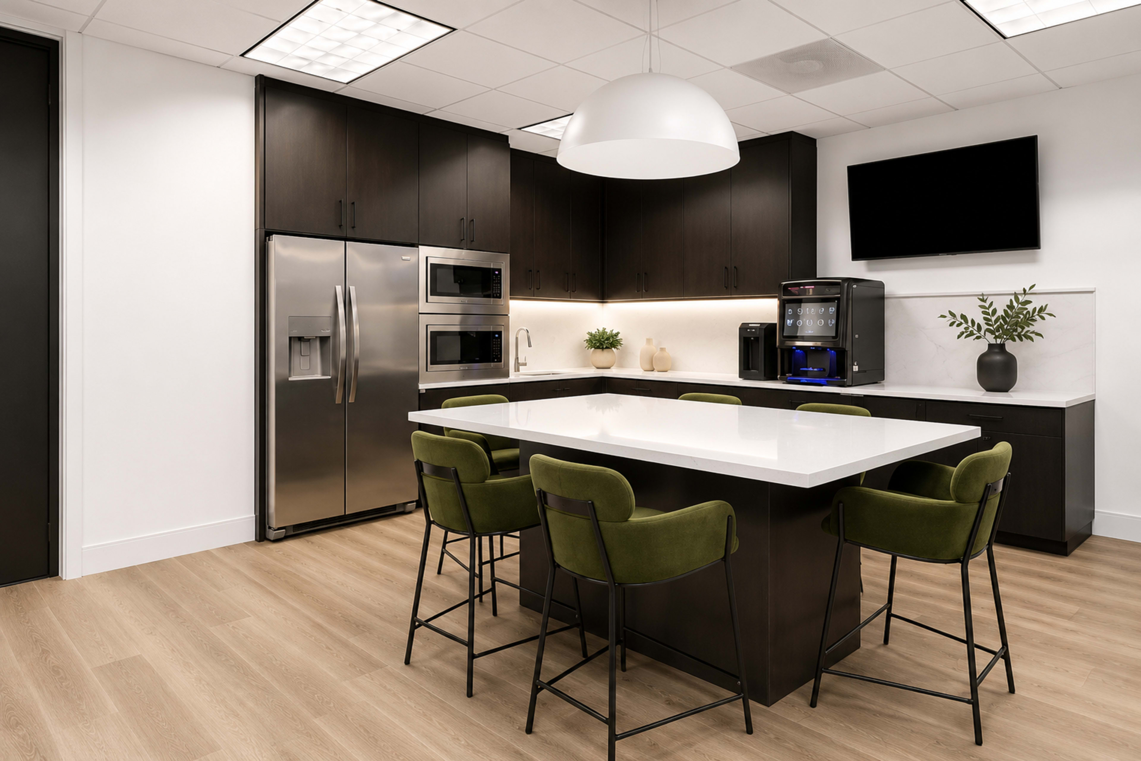 The image shows a modern kitchen with dark cabinets, stainless steel appliances, a white marble island, and green bar stools.