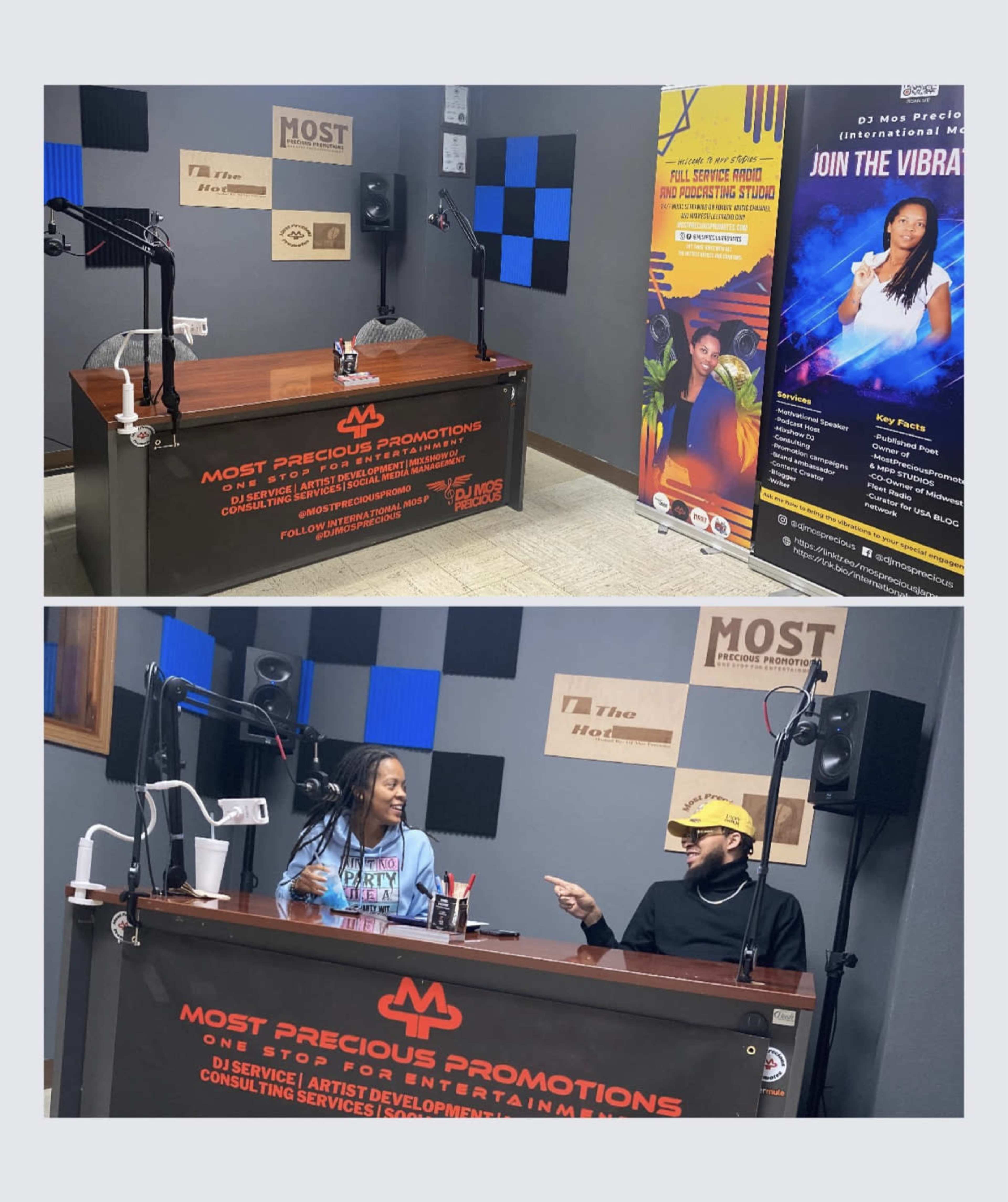 A recording studio setup with a table, microphones, and promotional banners, featuring a seated woman and a man engaged in conversation.
