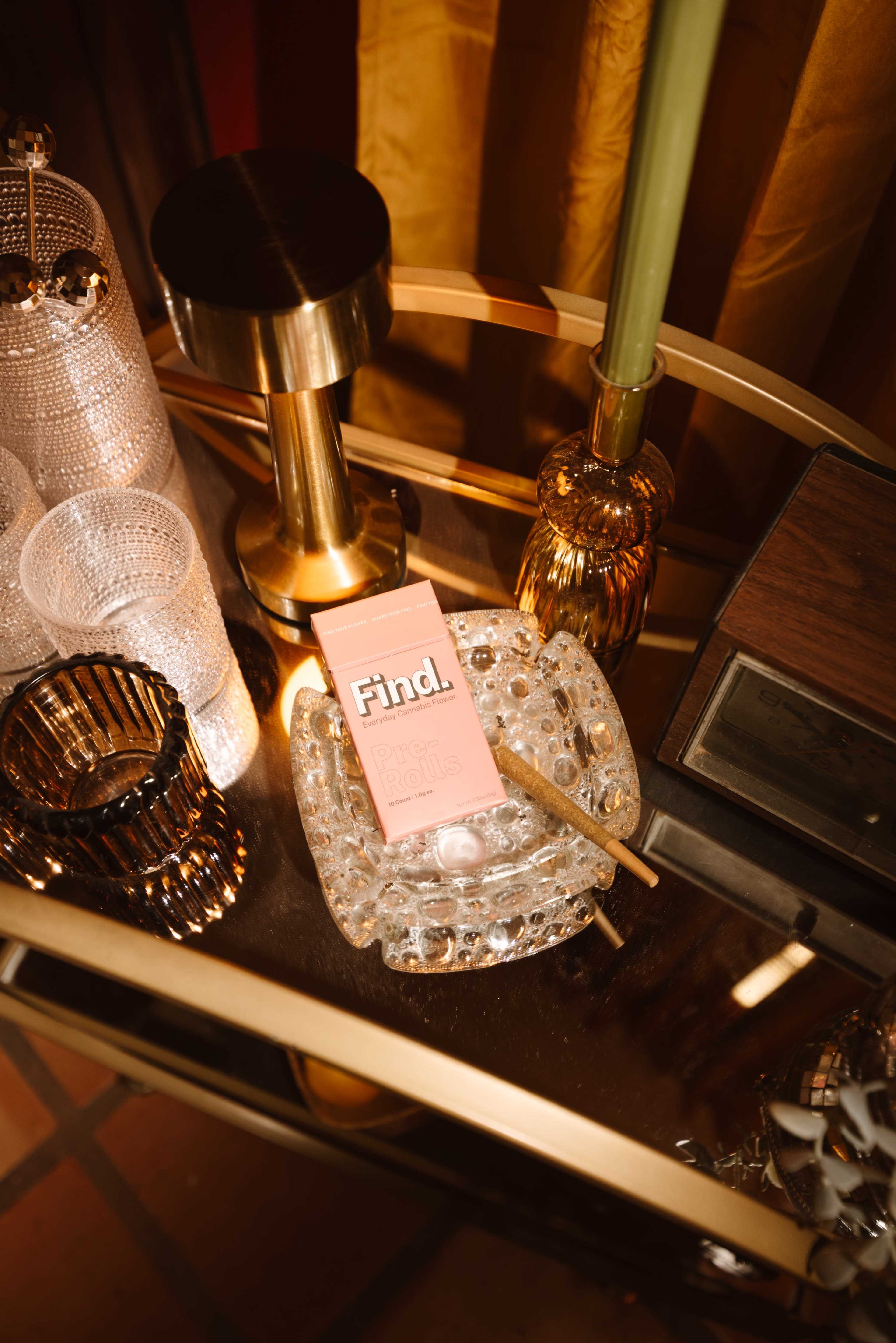A decorative cart holds various crystal and metallic objects, with a pink box labeled "Find." prominently featured.