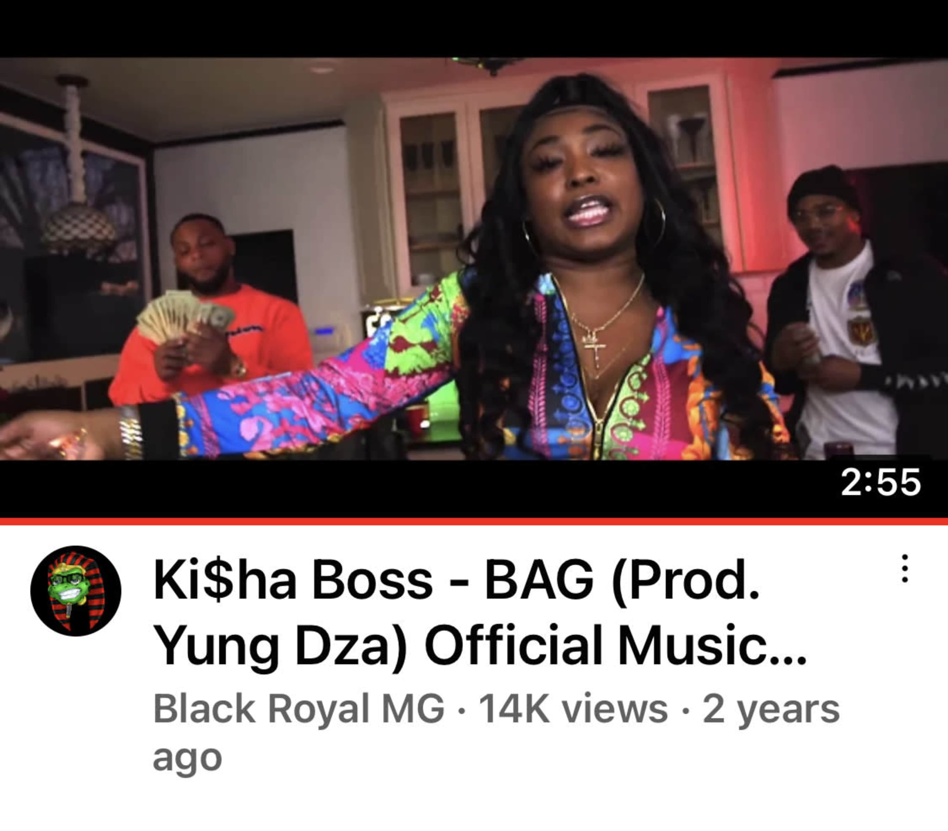 A woman with long hair performs in a music video while holding cash in a brightly lit room.