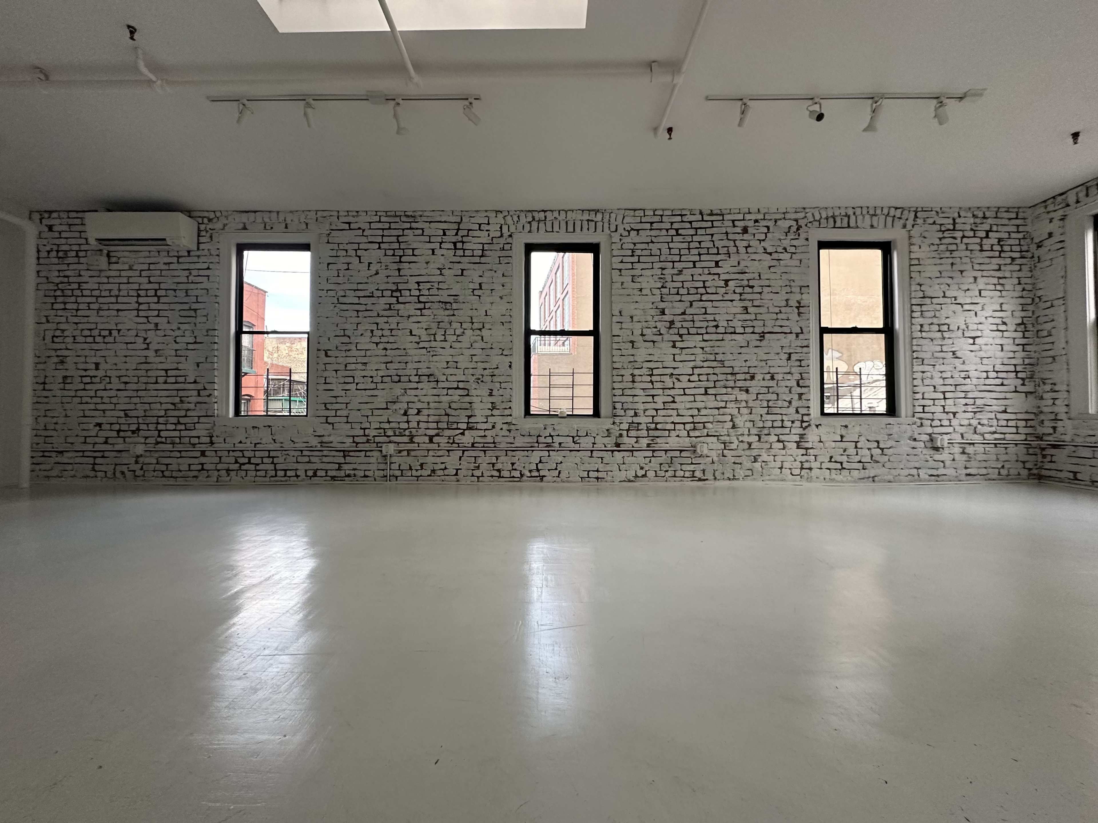 Artistic All-White Loft with Walls of Windows, Skylight & Unique Props Image in Little Italy, New York, NY