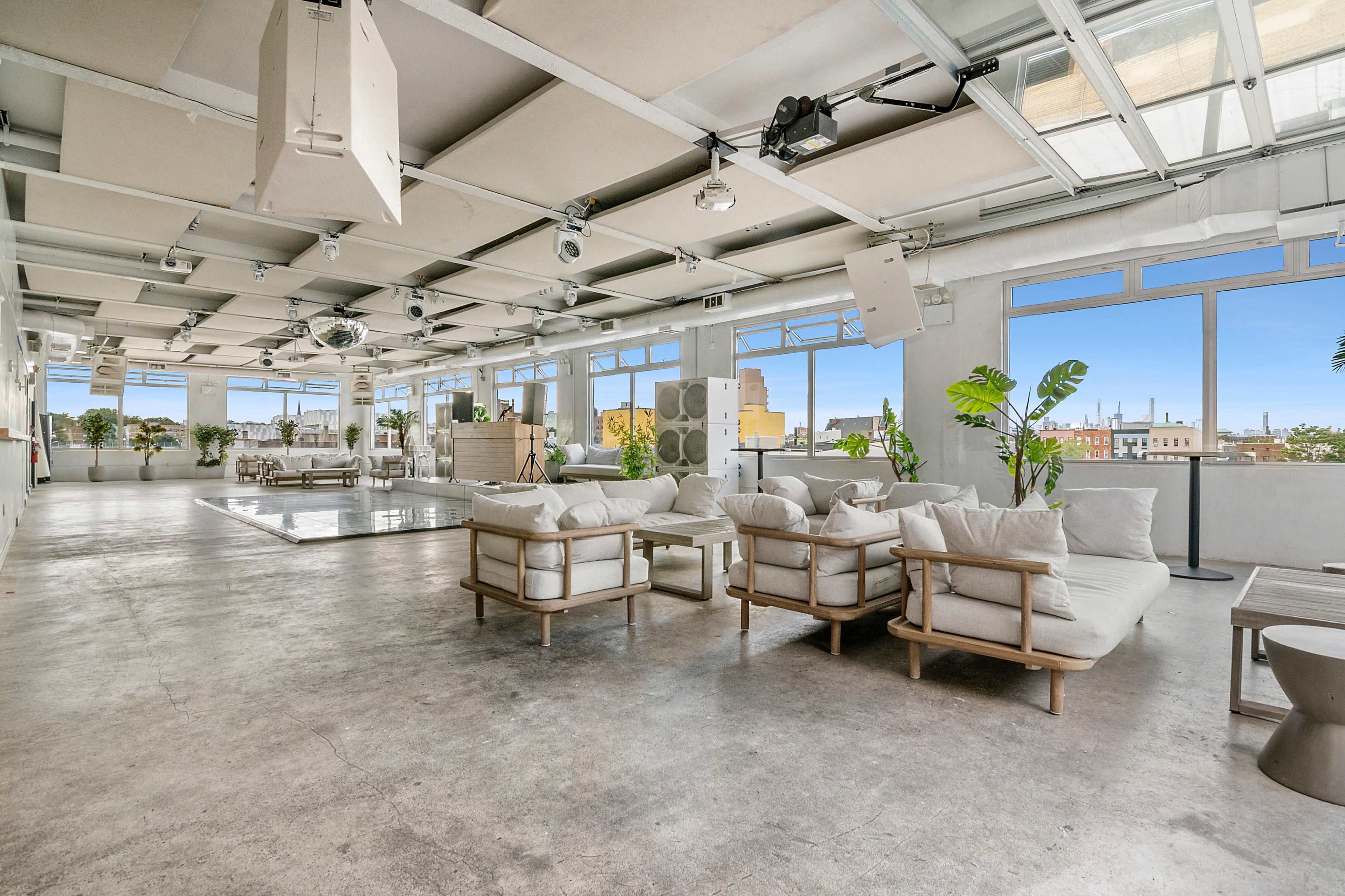 A spacious, modern interior with large windows, minimalist seating, and a central pool area.