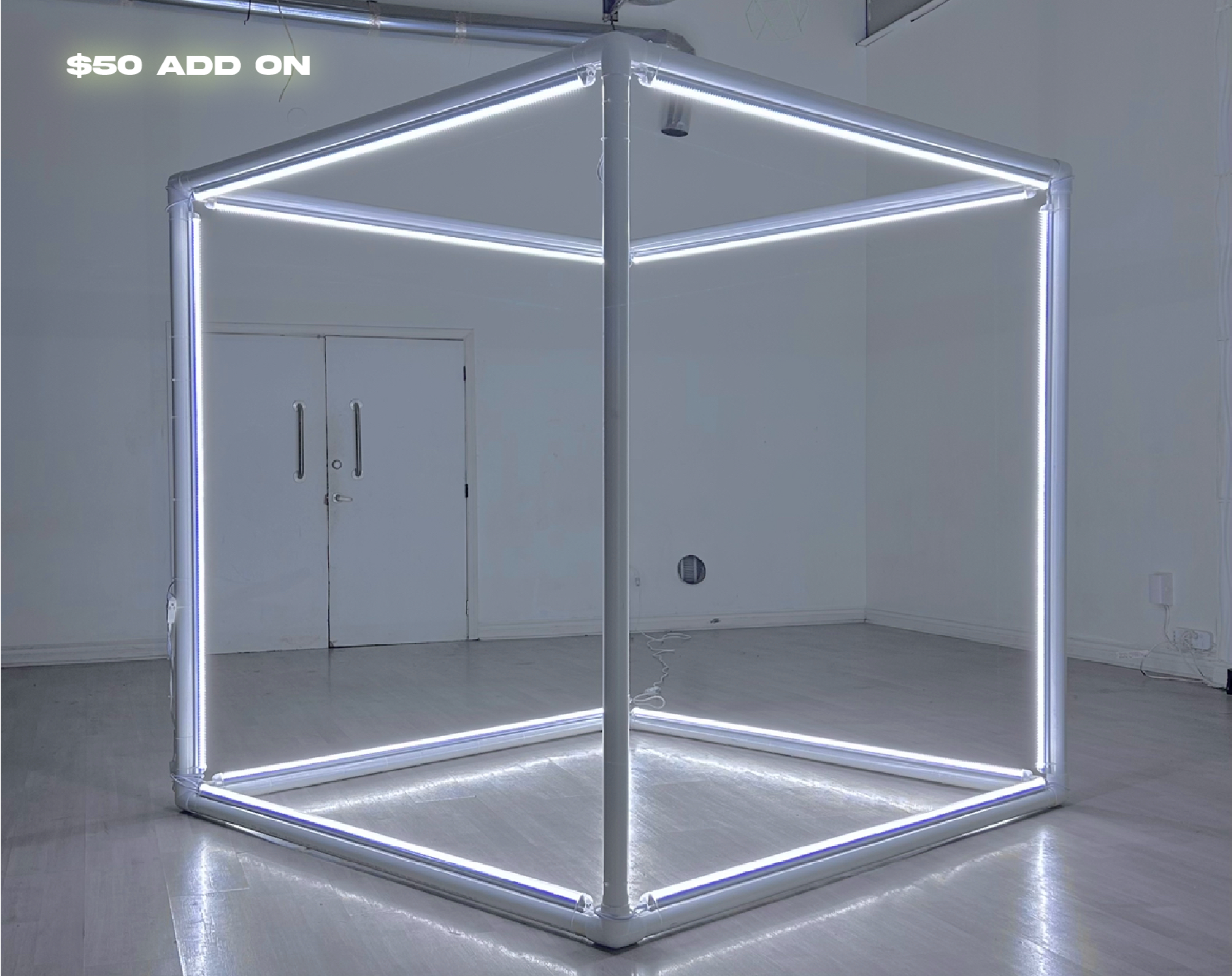 A large, illuminated square frame made of LED lights stands in a minimalist room with white walls and a polished floor.