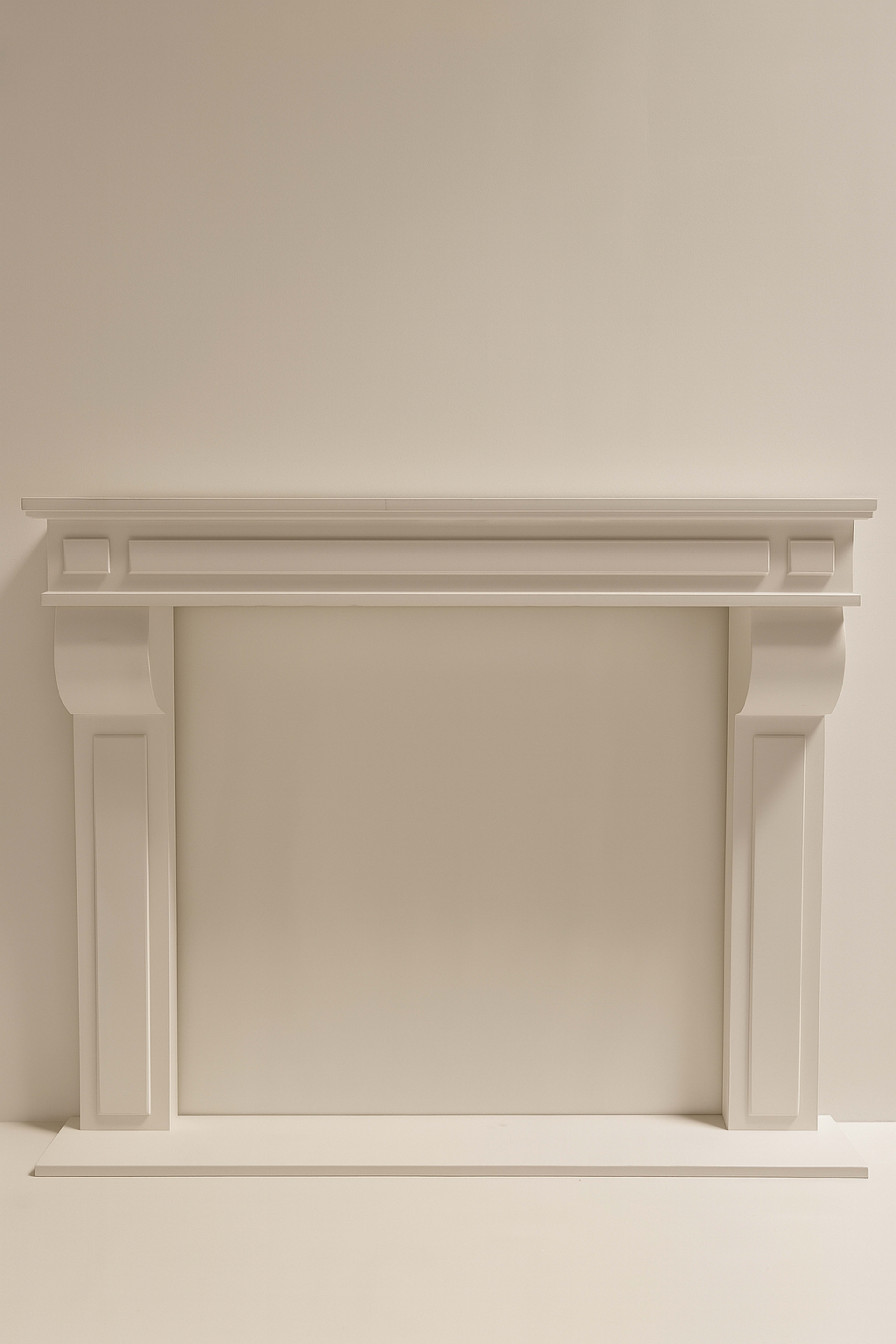 The image shows a white, minimalist fireplace mantel set against a plain background.