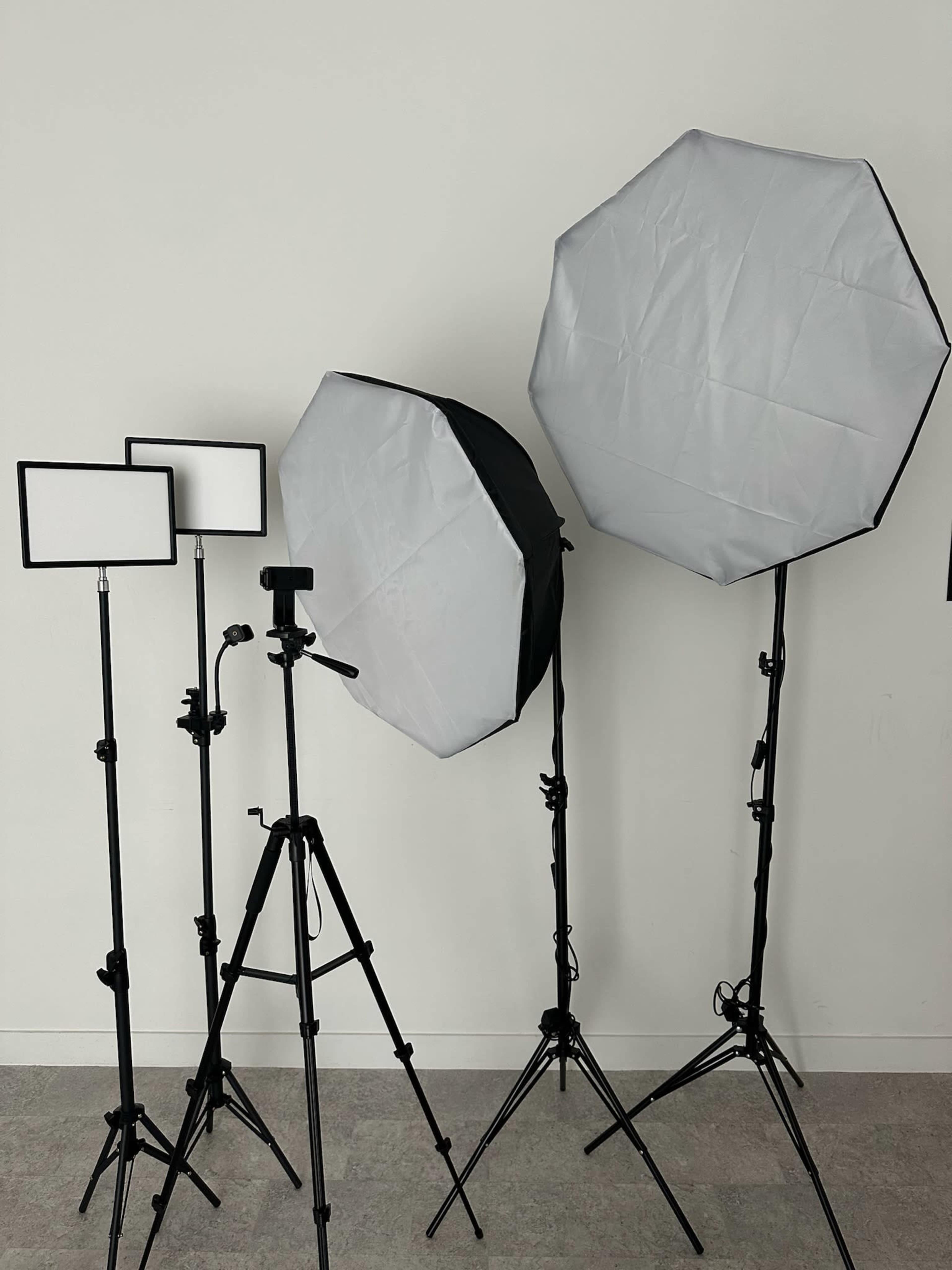 A setup of photography lighting equipment, including two large octagonal softboxes and several smaller LED panels on stands.