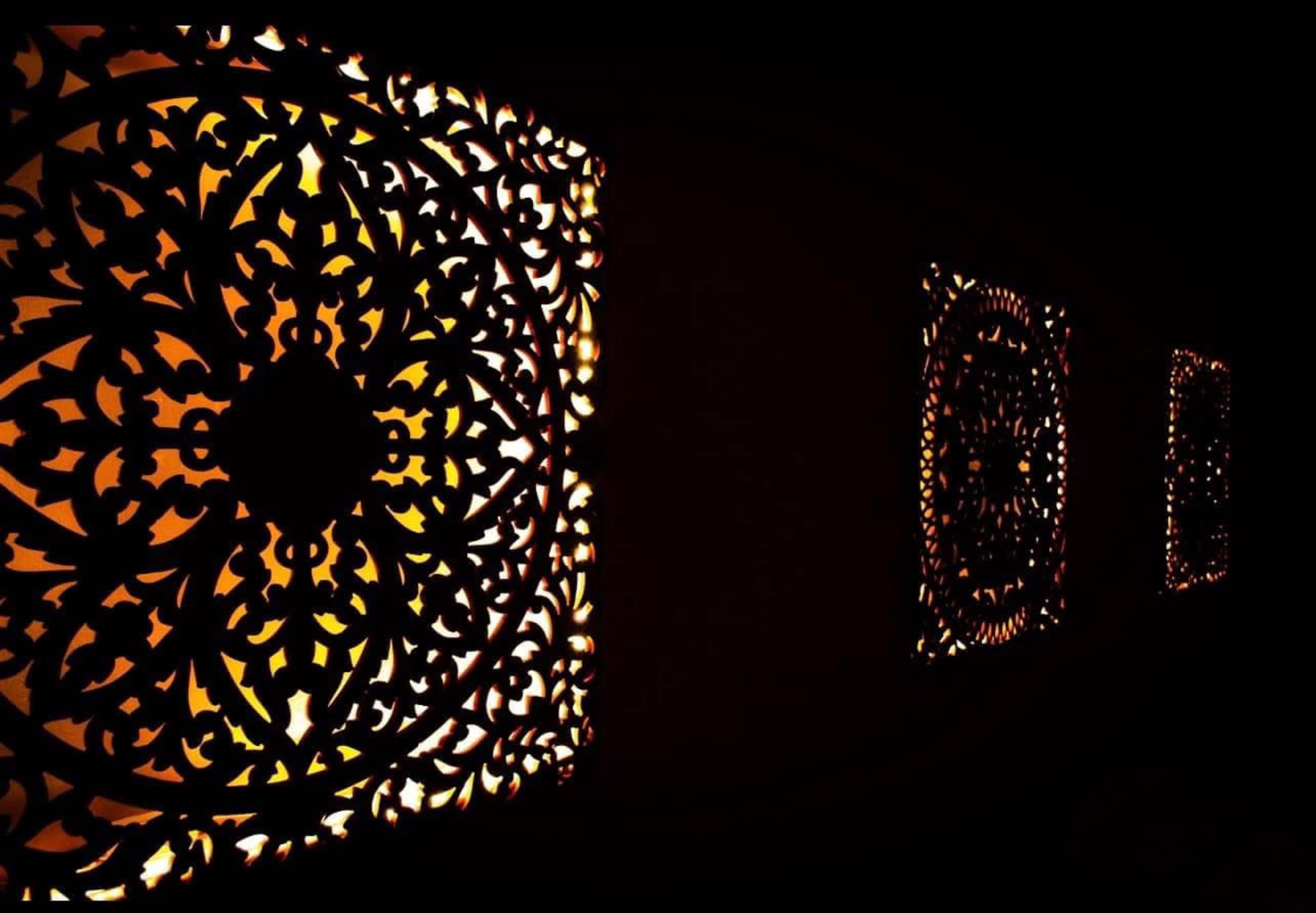 Intricately designed decorative panels that cast intricate shadow patterns on the wall.