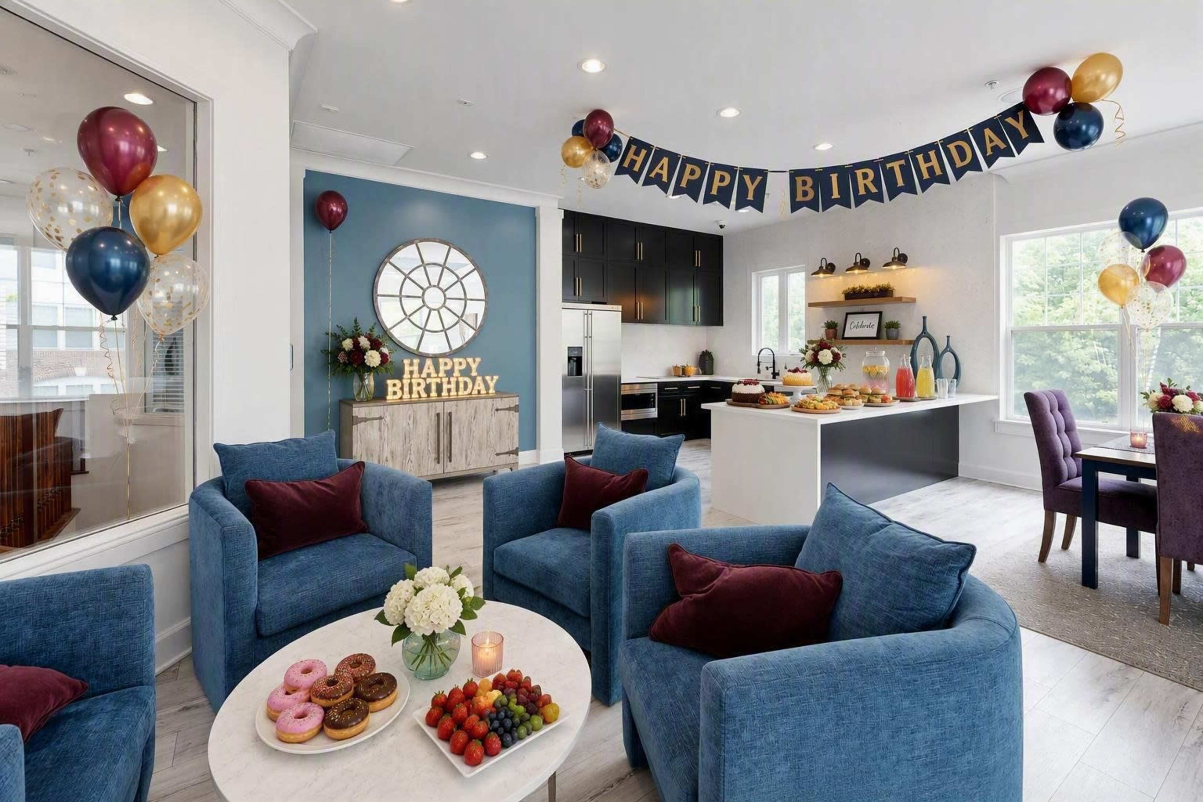 The image shows a decorated living space set up for a birthday celebration, featuring a "Happy Birthday" banner, balloons, and a table with various foods and snacks.