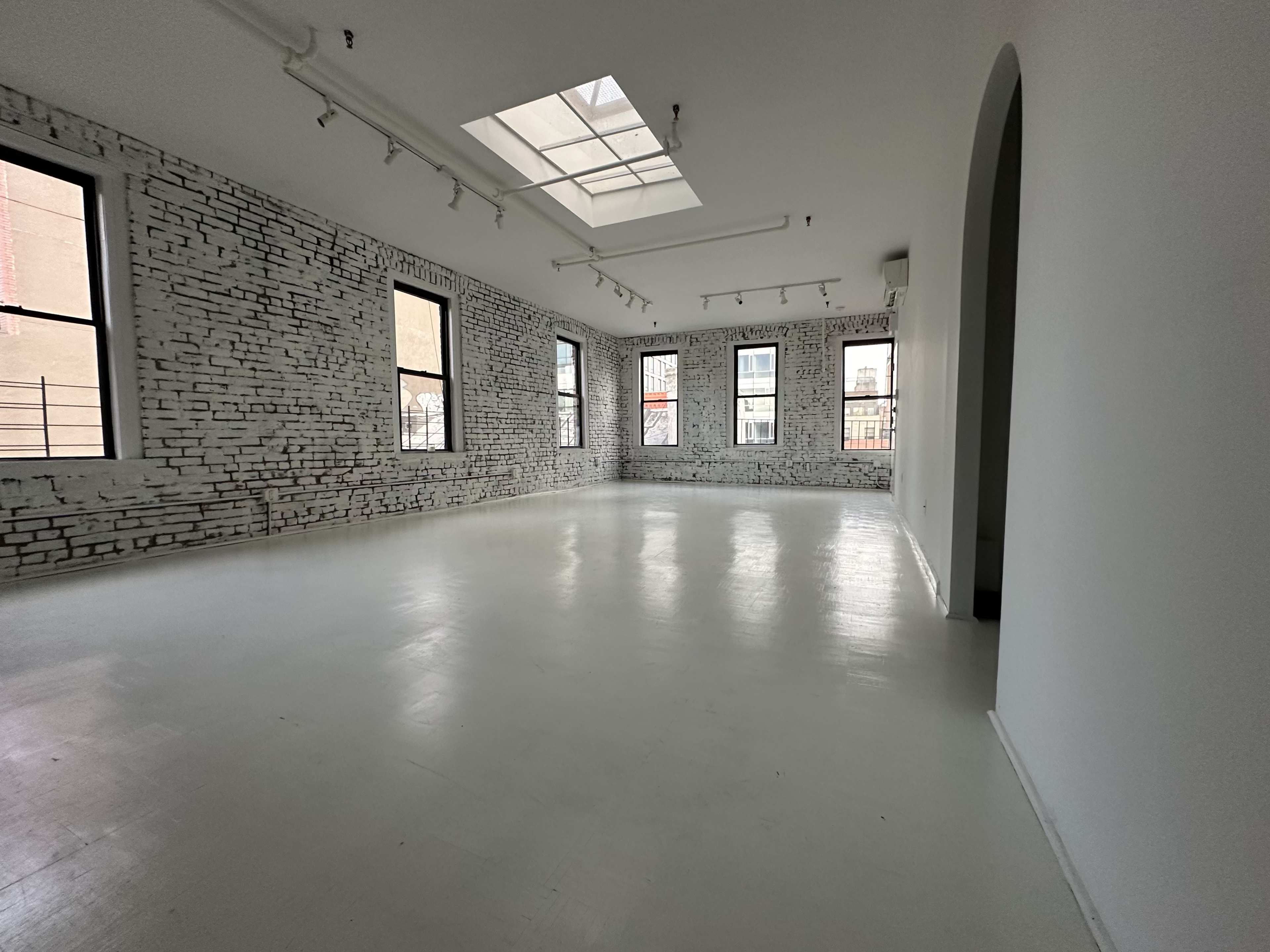 Artistic All-White Loft with Walls of Windows, Skylight & Unique Props Image in Little Italy, New York, NY