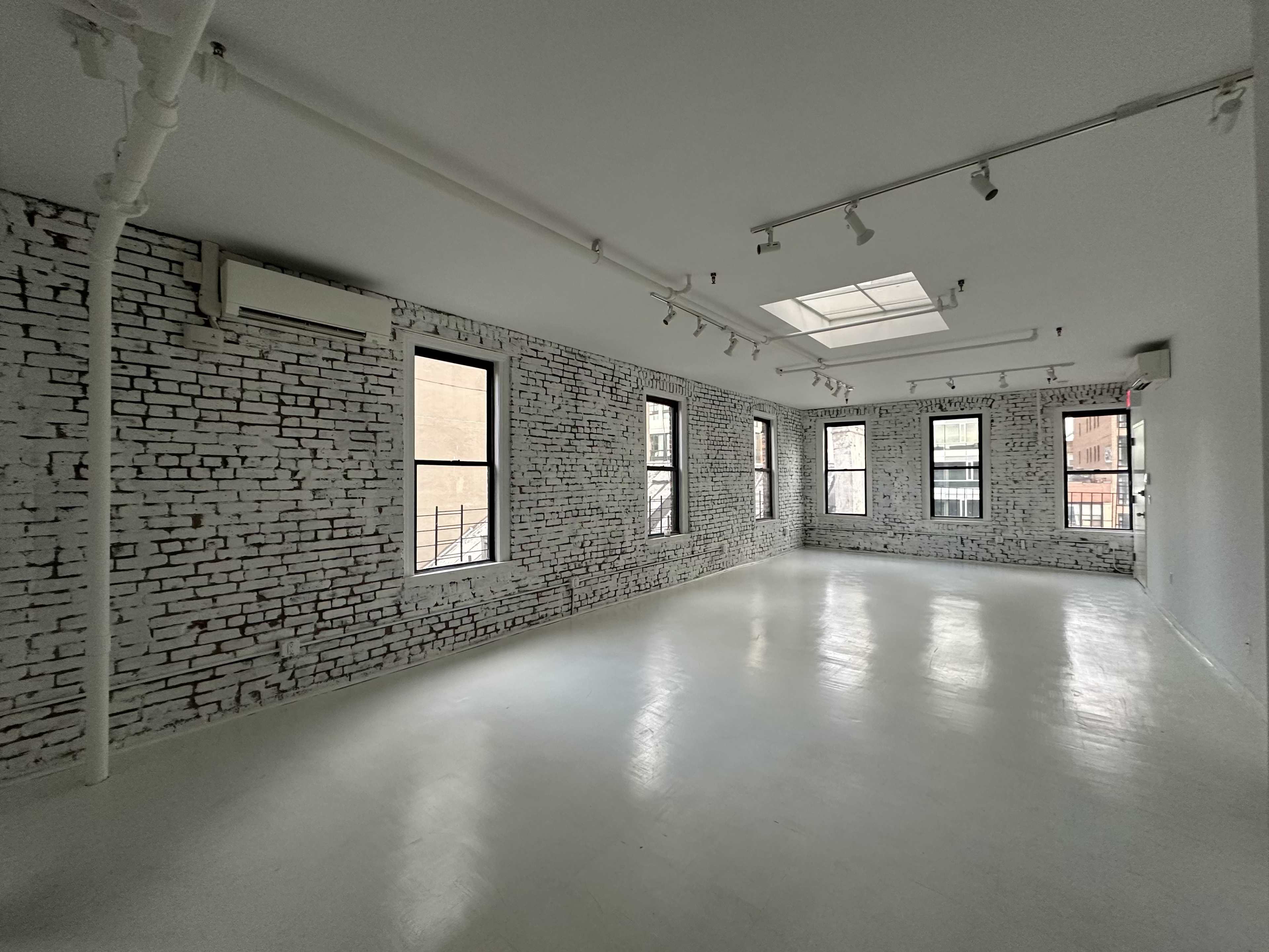 Artistic All-White Loft with Walls of Windows, Skylight & Unique Props Image in Little Italy, New York, NY