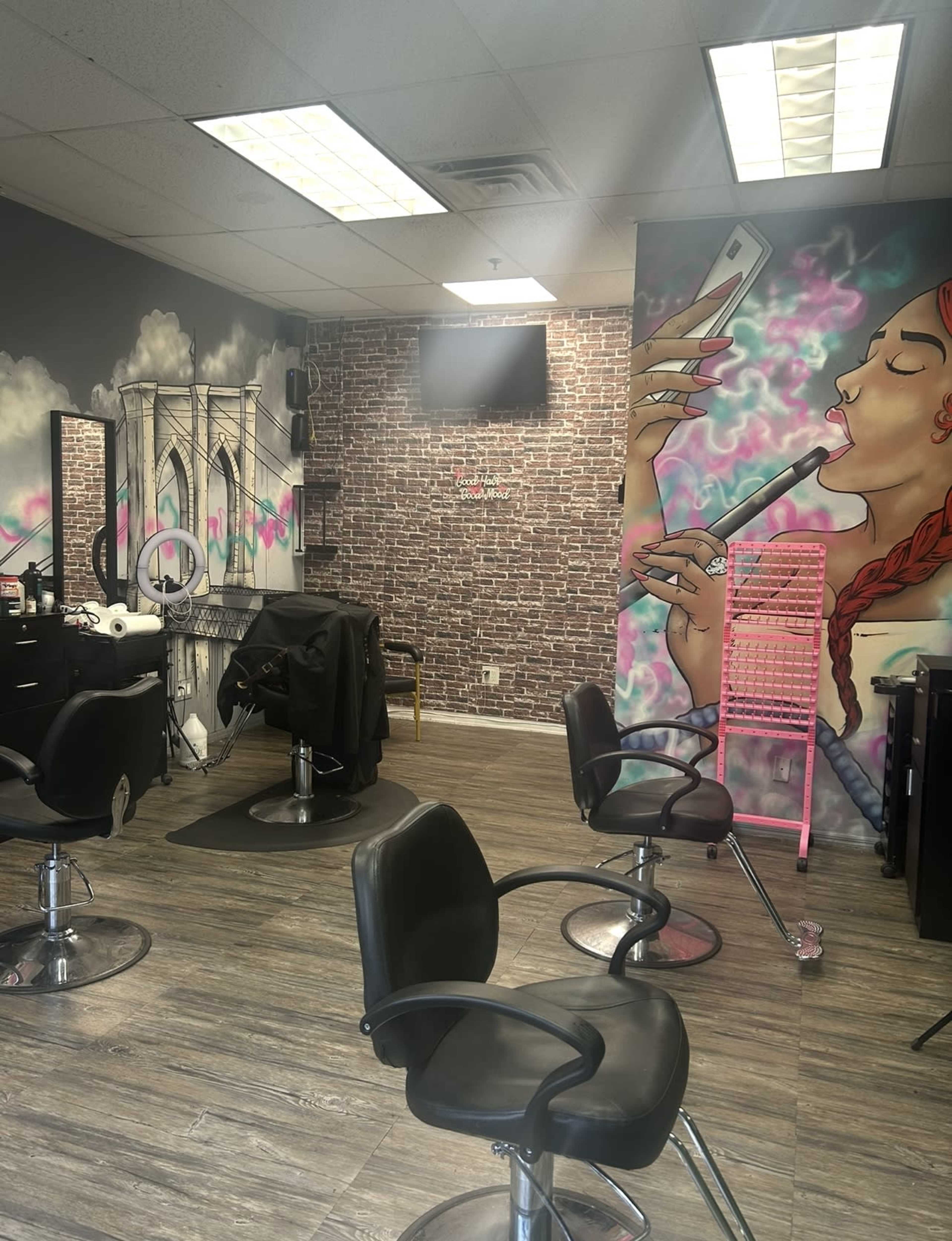 The image shows a hair salon with colorful wall murals, salon chairs, and a styling station.