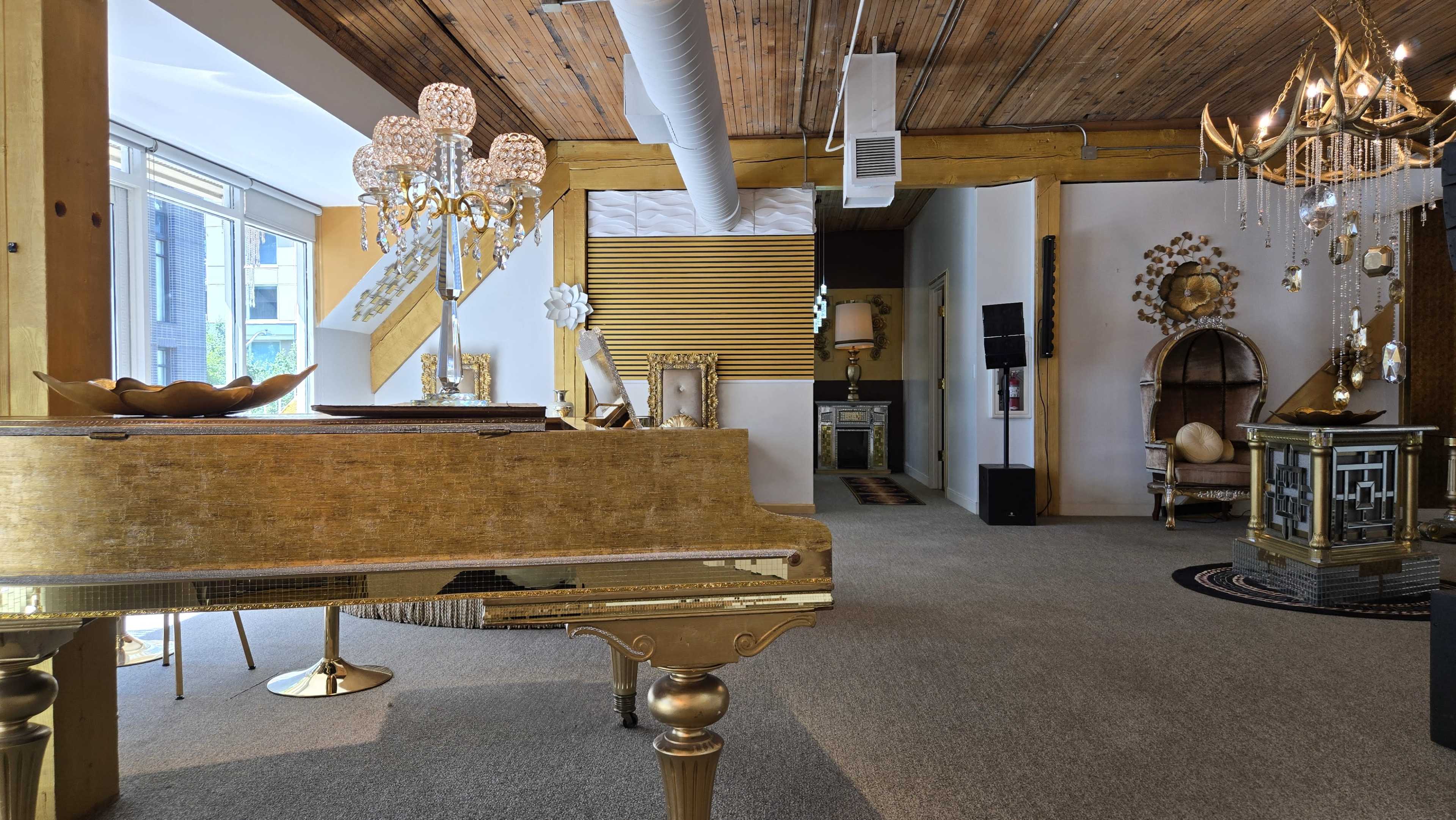 The scene features a richly decorated interior with ornate furniture, including a golden piano and various elegant light fixtures, under a wooden ceiling.
