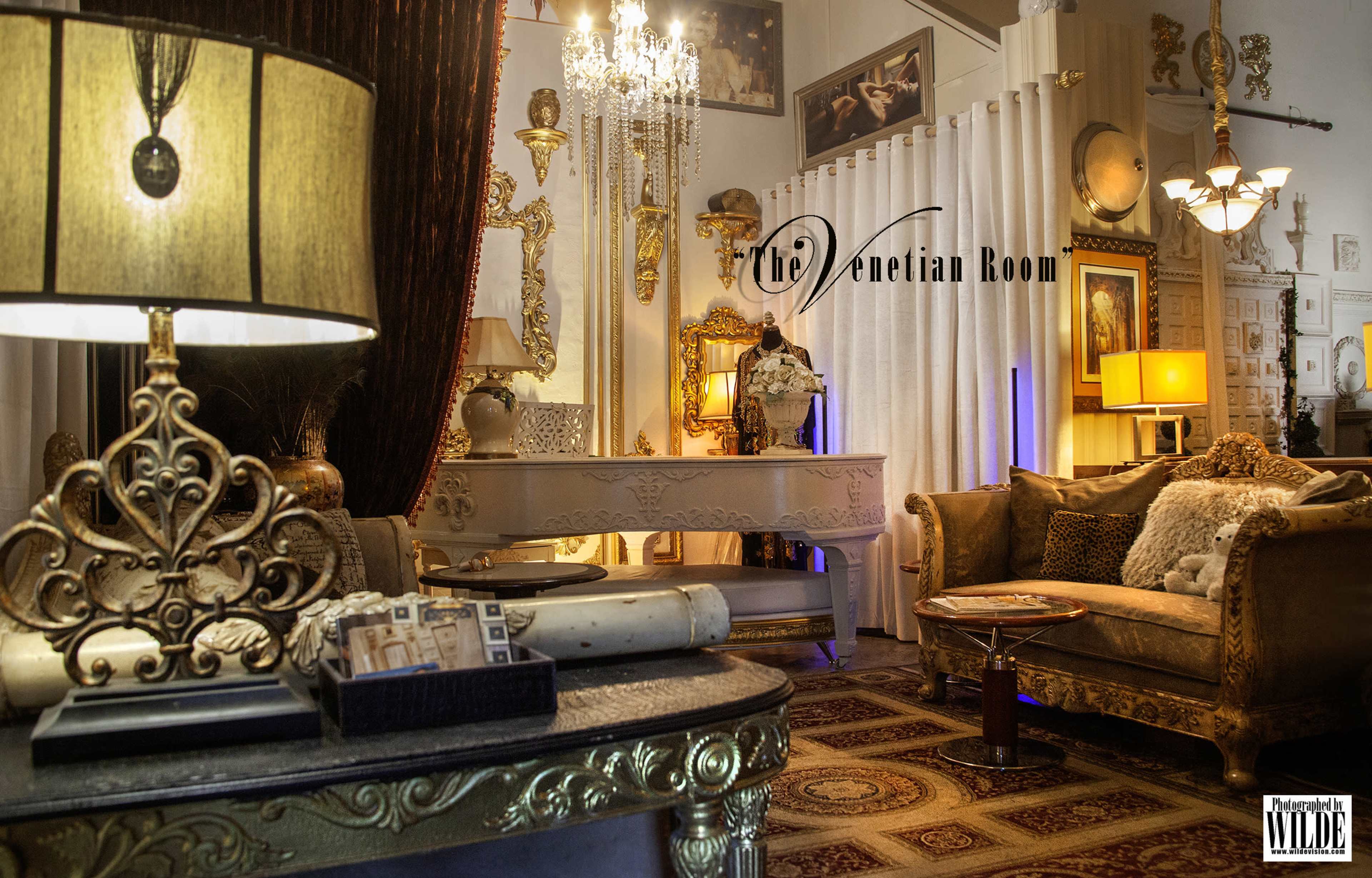 The image shows an elegantly decorated living room with ornate furniture, a chandelier, and a combination of modern and classic decor elements.