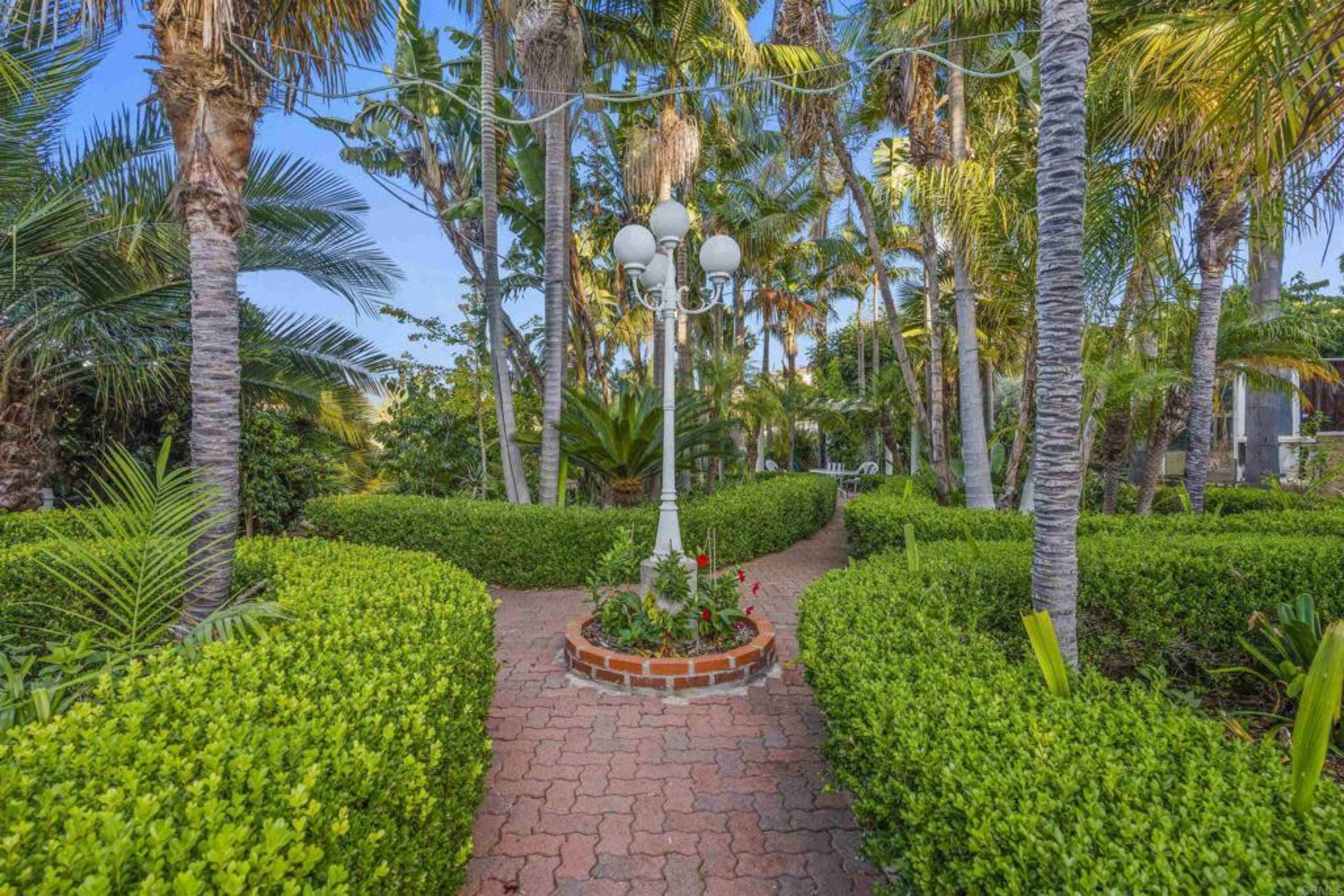 Elegant Outdoor Oasis with Lush Gardens, Pool, and Patios—Perfect for Daytime Events in Vista Image in , Vista, CA