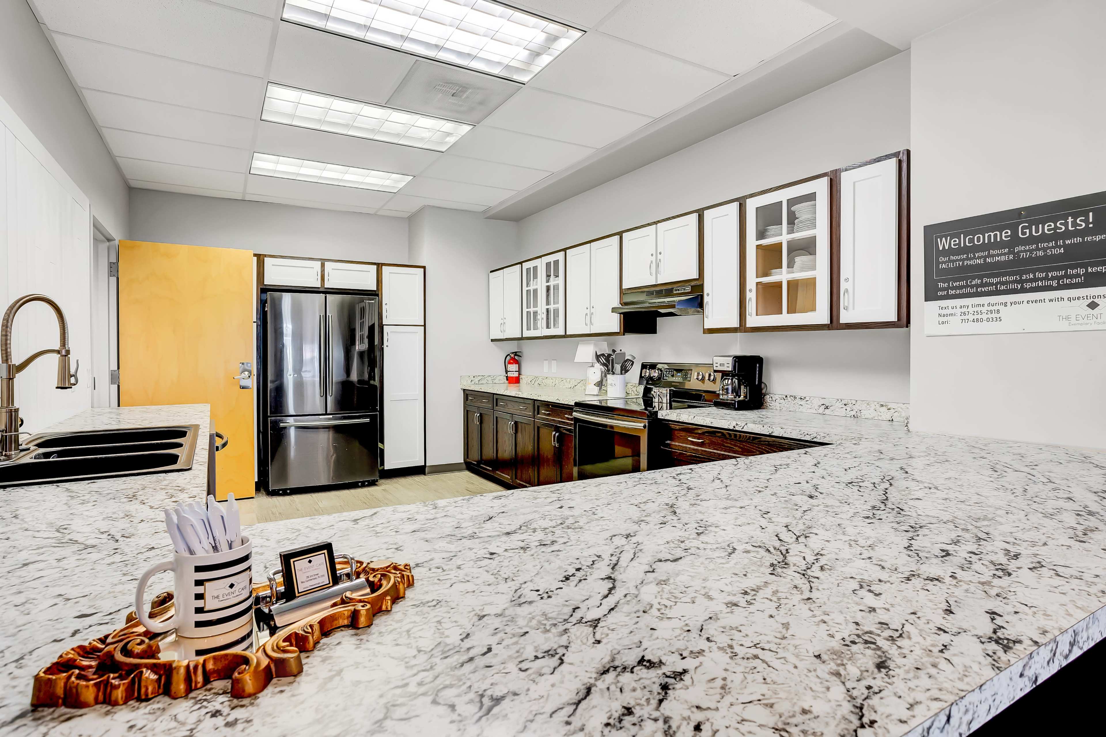 The kitchen features a granite countertop, modern appliances, and wooden cabinetry.