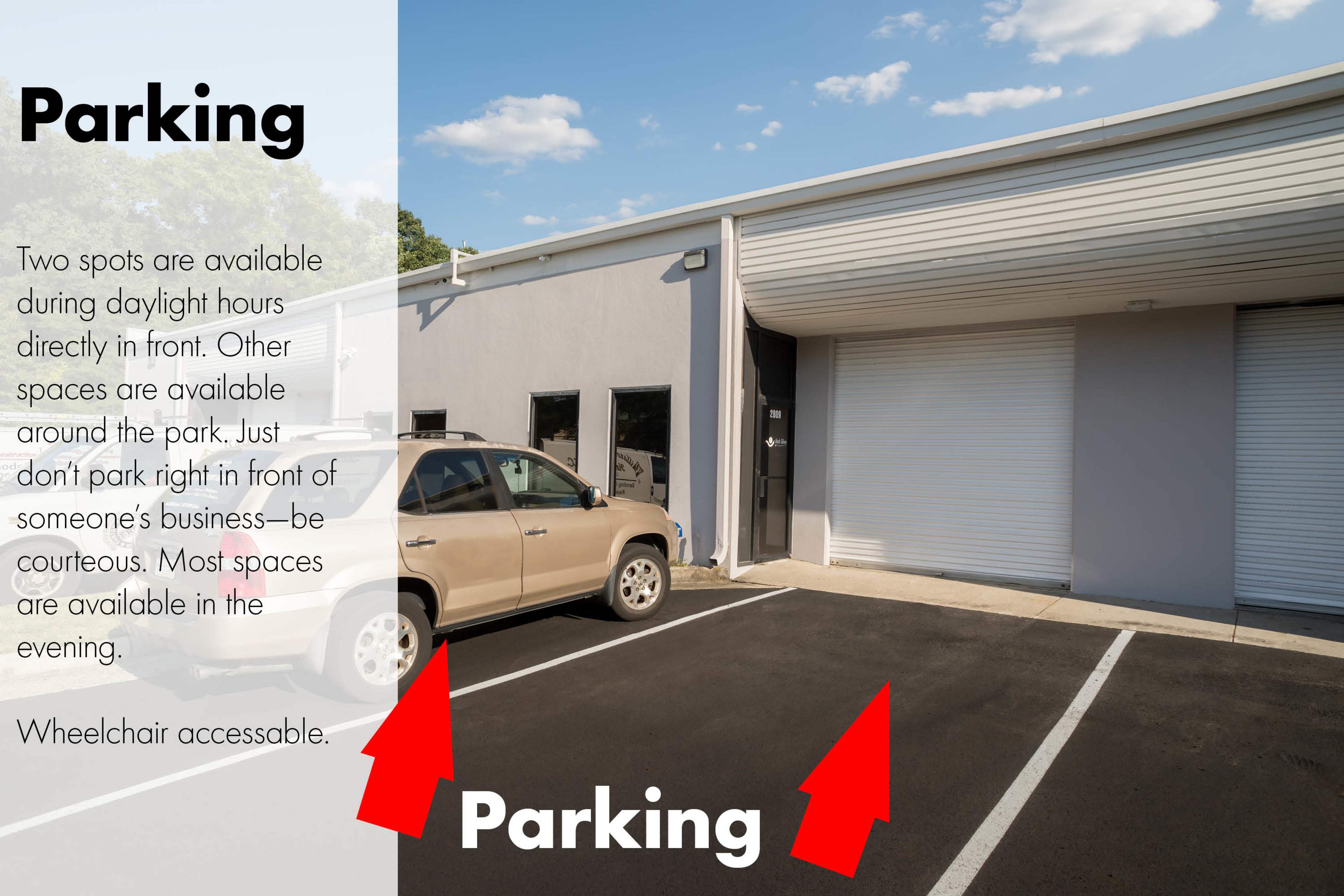 A parking area with two spots designated for daylight use, alongside a building with a loading dock and several parked vehicles.