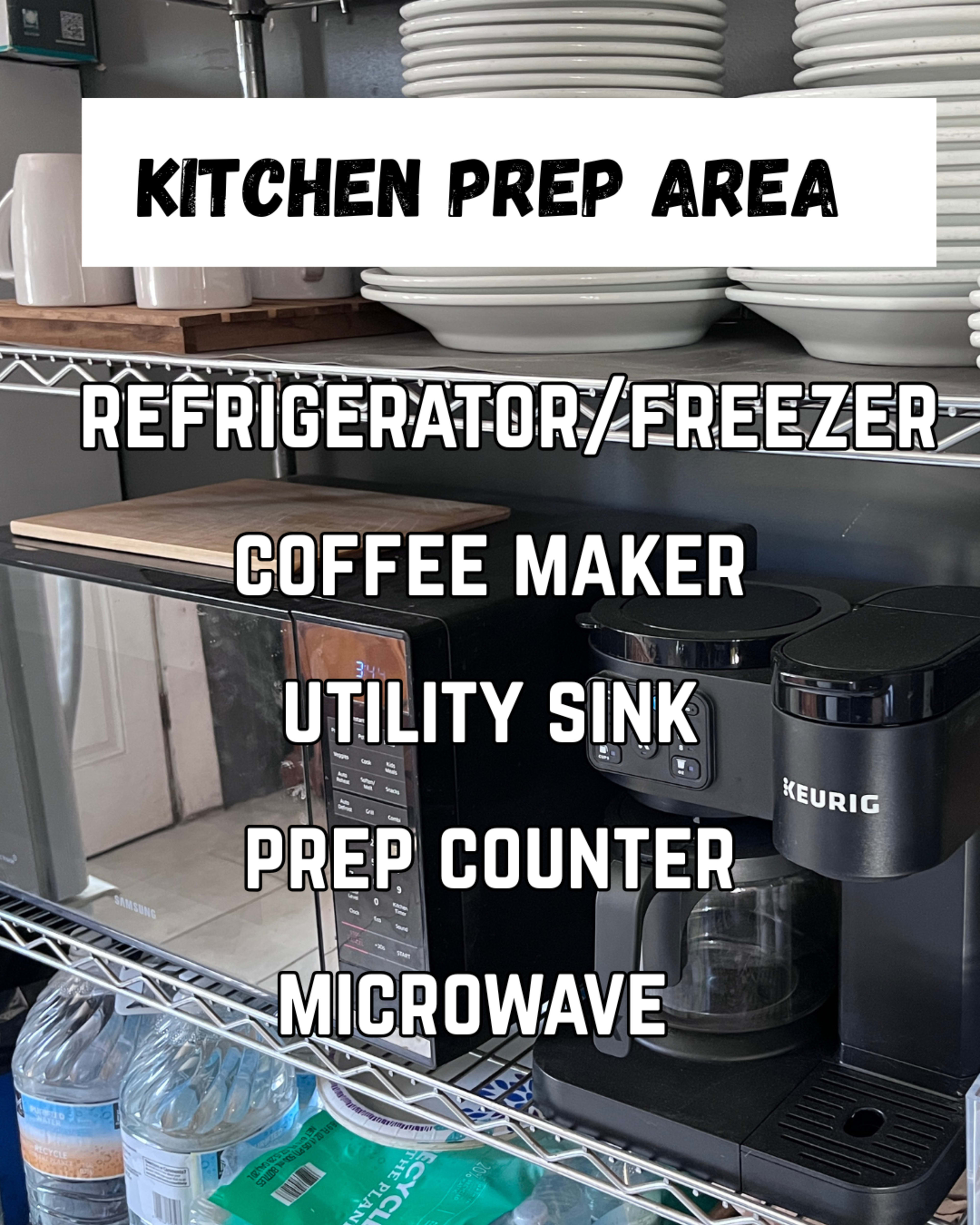 The image shows a kitchen prep area featuring a refrigerator/freezer, coffee maker, utility sink, prep counter, and microwave.