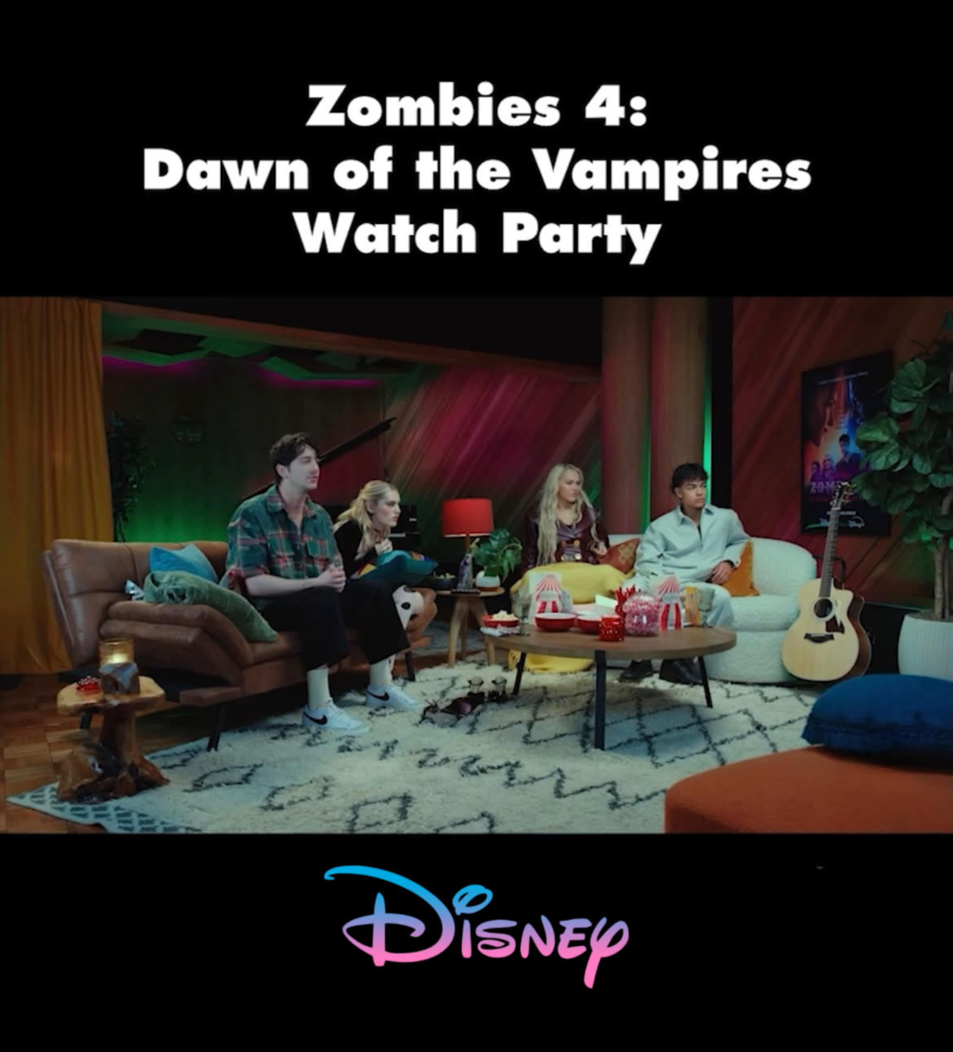 A group of four young people is sitting on a couch in a colorful room, watching a movie together during a Disney-themed watch party for "Zombies 4: Dawn of the Vampires."