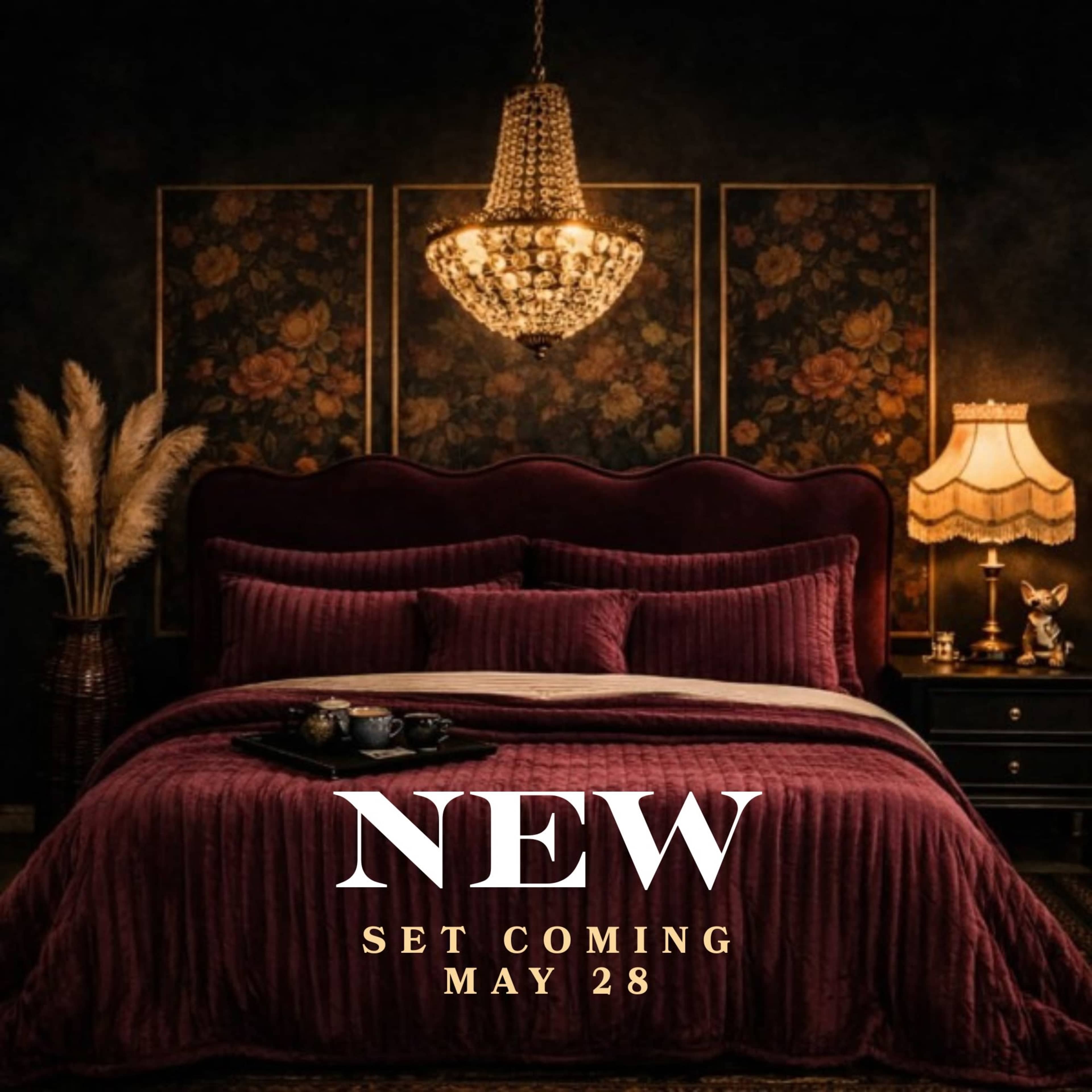 The image features a luxurious bedroom with a burgundy bedspread, an ornate chandelier, and floral artwork on the dark walls.