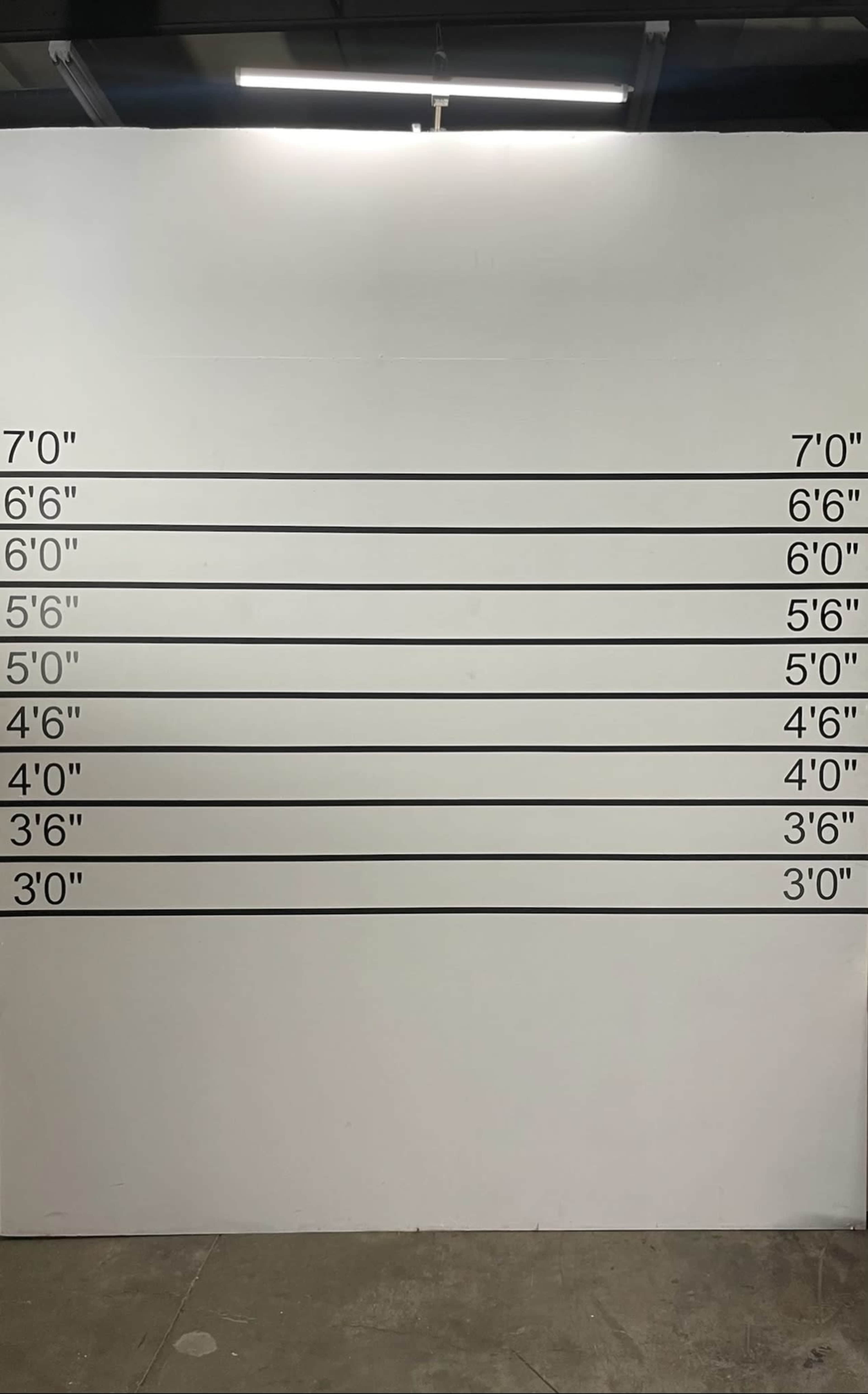 A white wall with height markings ranging from 3 feet to 7 feet, each labeled in black text.