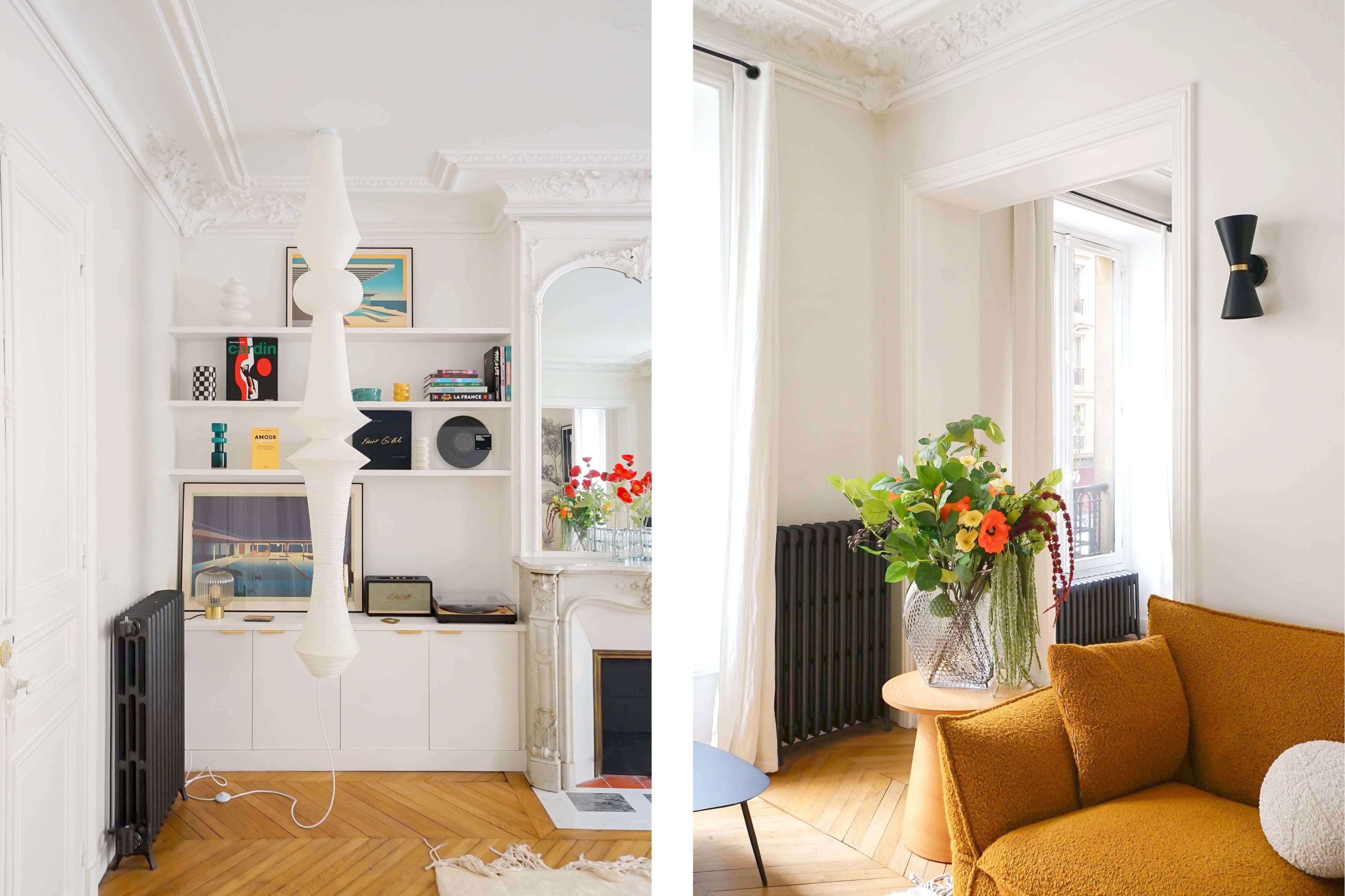 The image shows a bright, elegantly designed living room with contemporary furniture, decorative bookshelves, and vibrant flower arrangements.