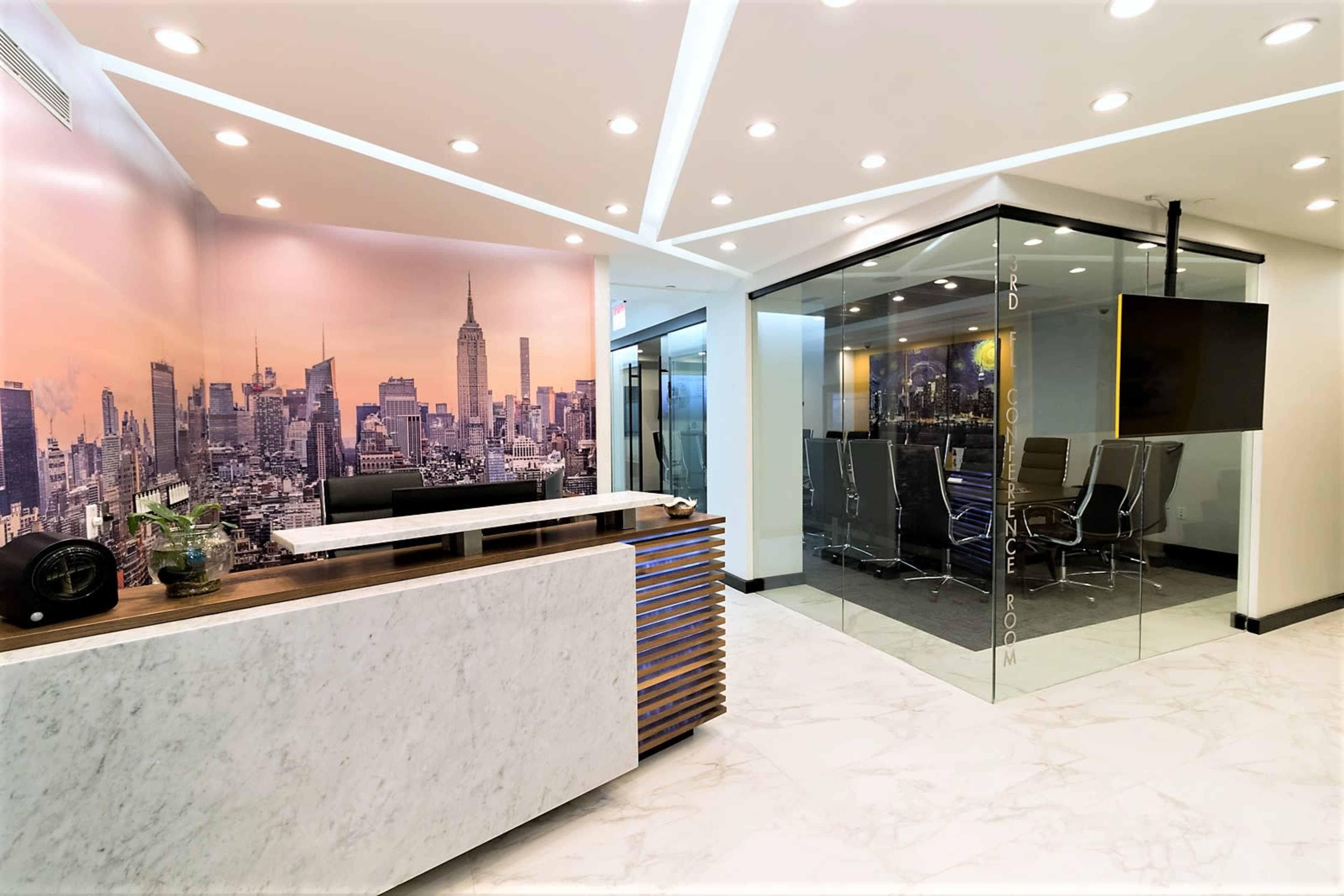 The image shows a modern office reception area with a marble desk, a large cityscape mural featuring skyscrapers, and a glass-walled conference room.