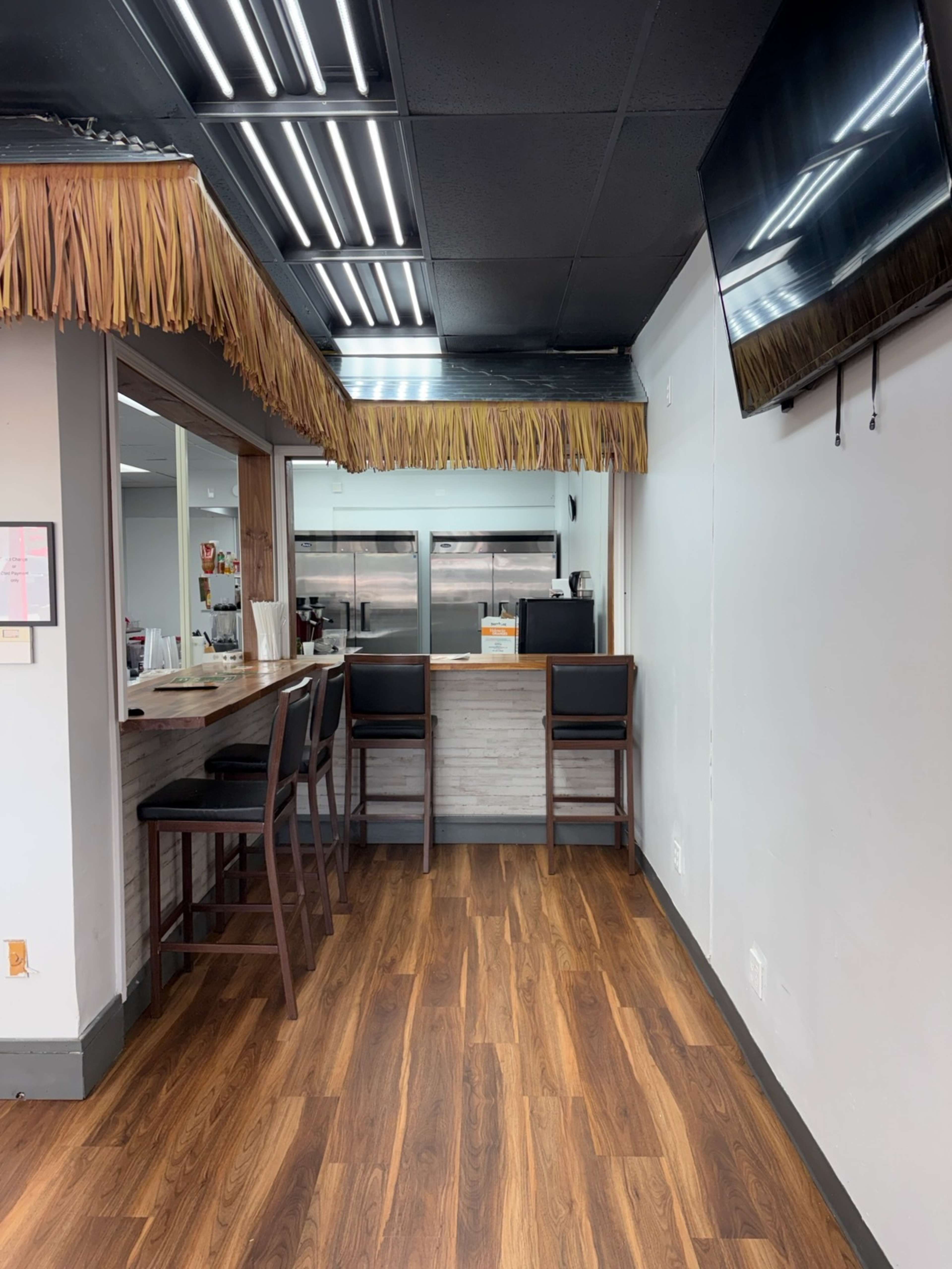 Open-Concept Juice Bar with Wood Bar, Greenery Wall & Café Seating Image in College Park, College Park, GA