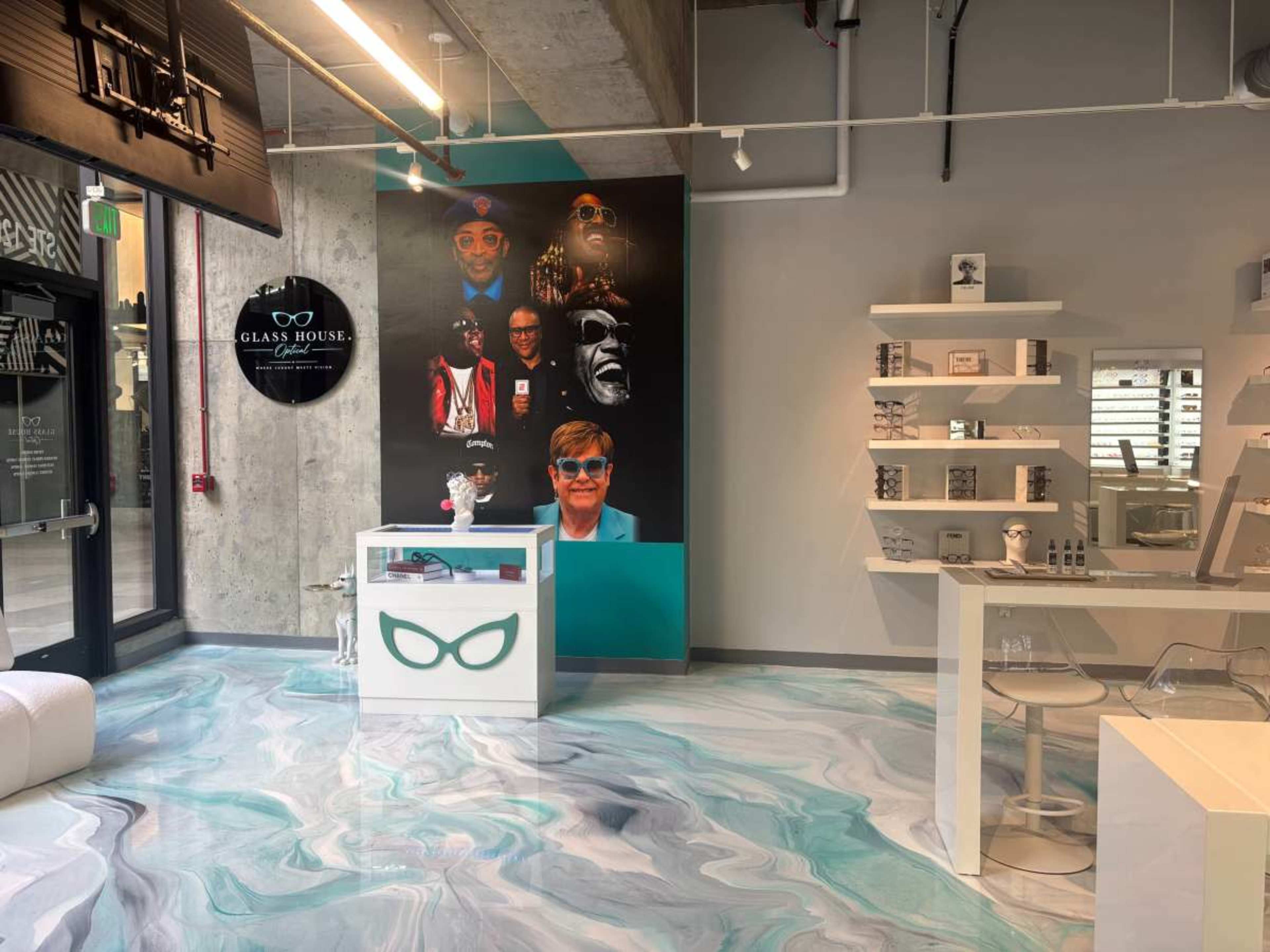 The image depicts a modern retail space featuring a colorful mural on the wall, several display shelves, and a counter with an innovative design.