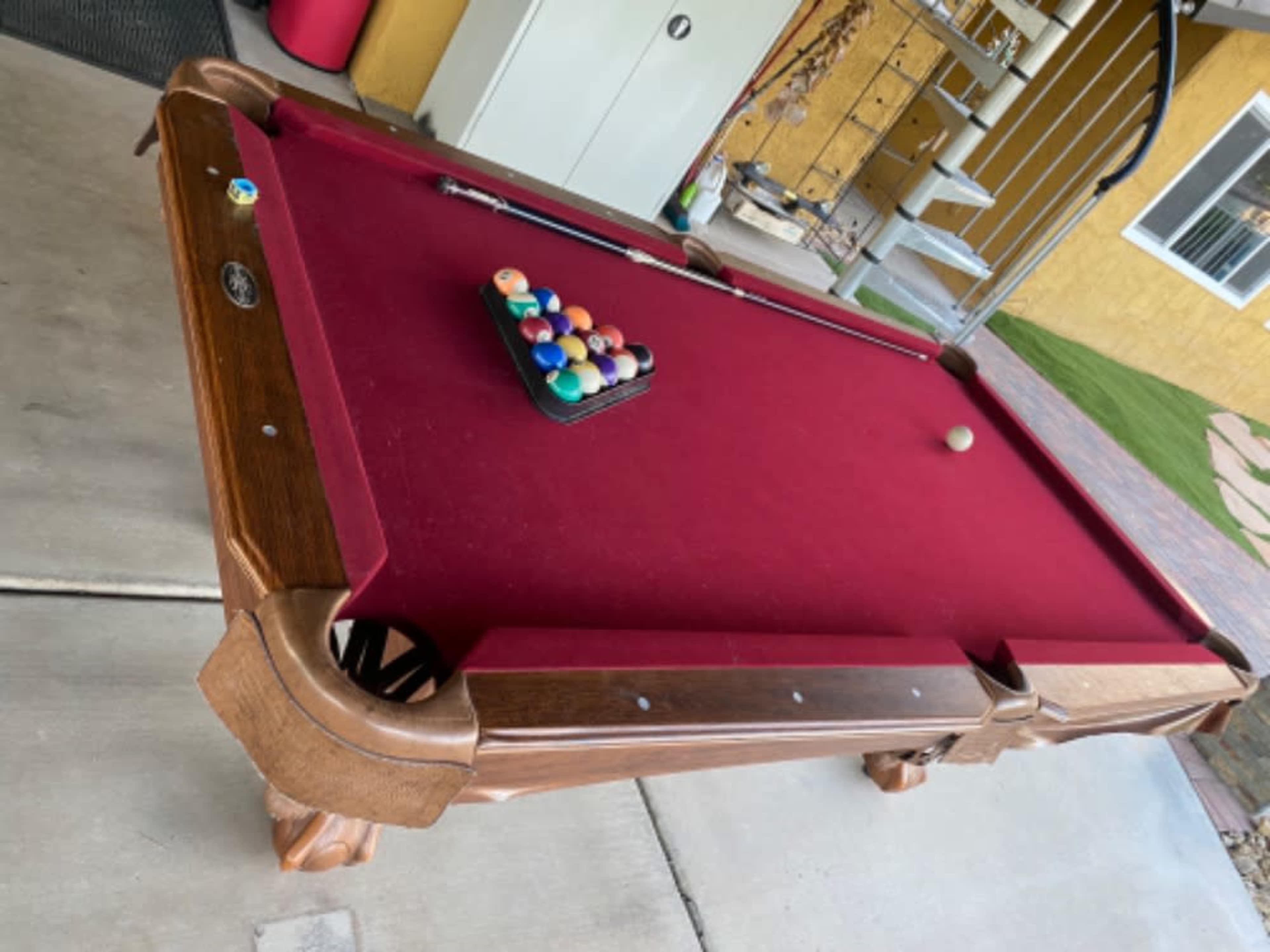 Pool table with balls and playing sticks 