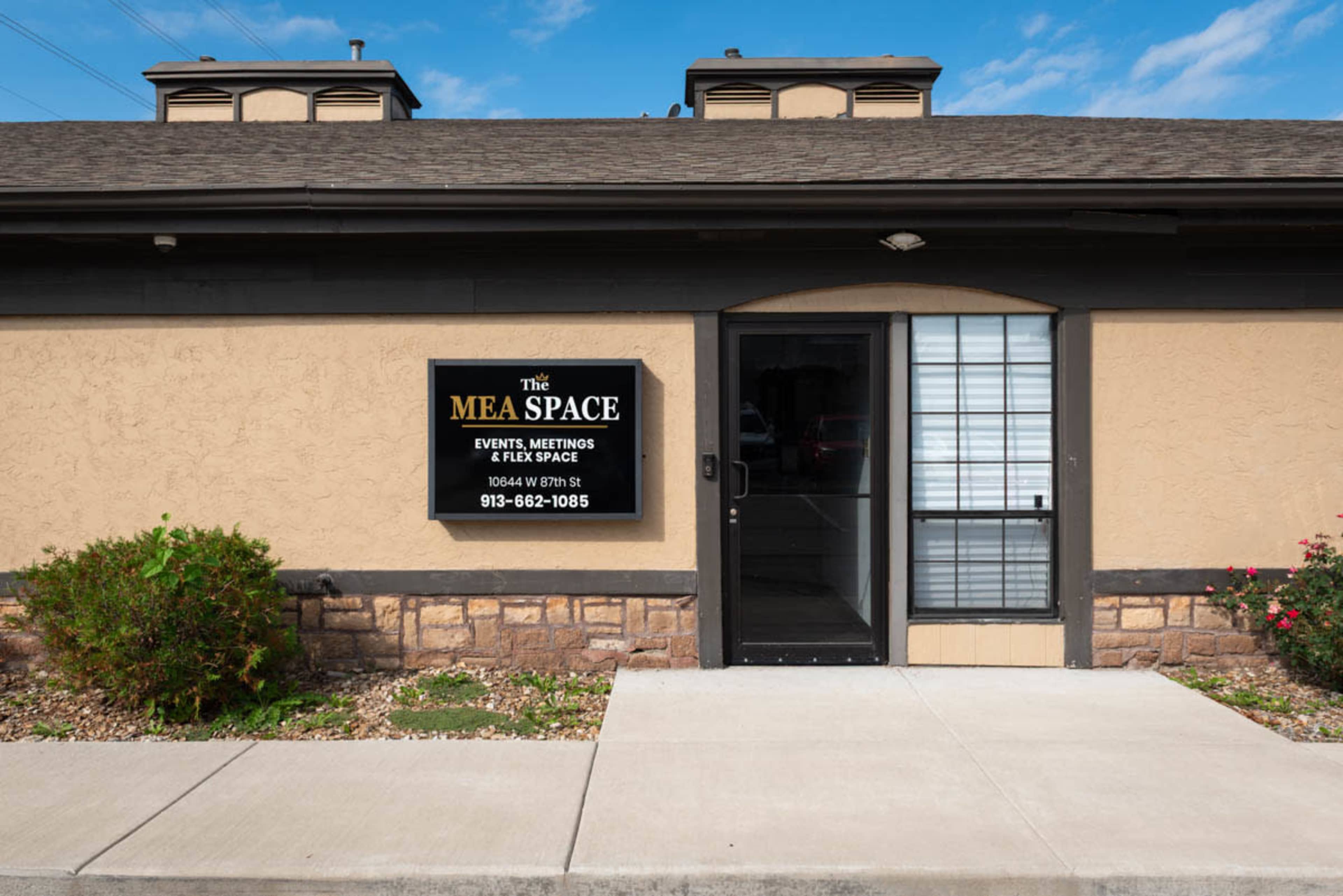 The image shows the entrance of a building with a sign that reads "The MBA Space," indicating it is a venue for events and meetings.