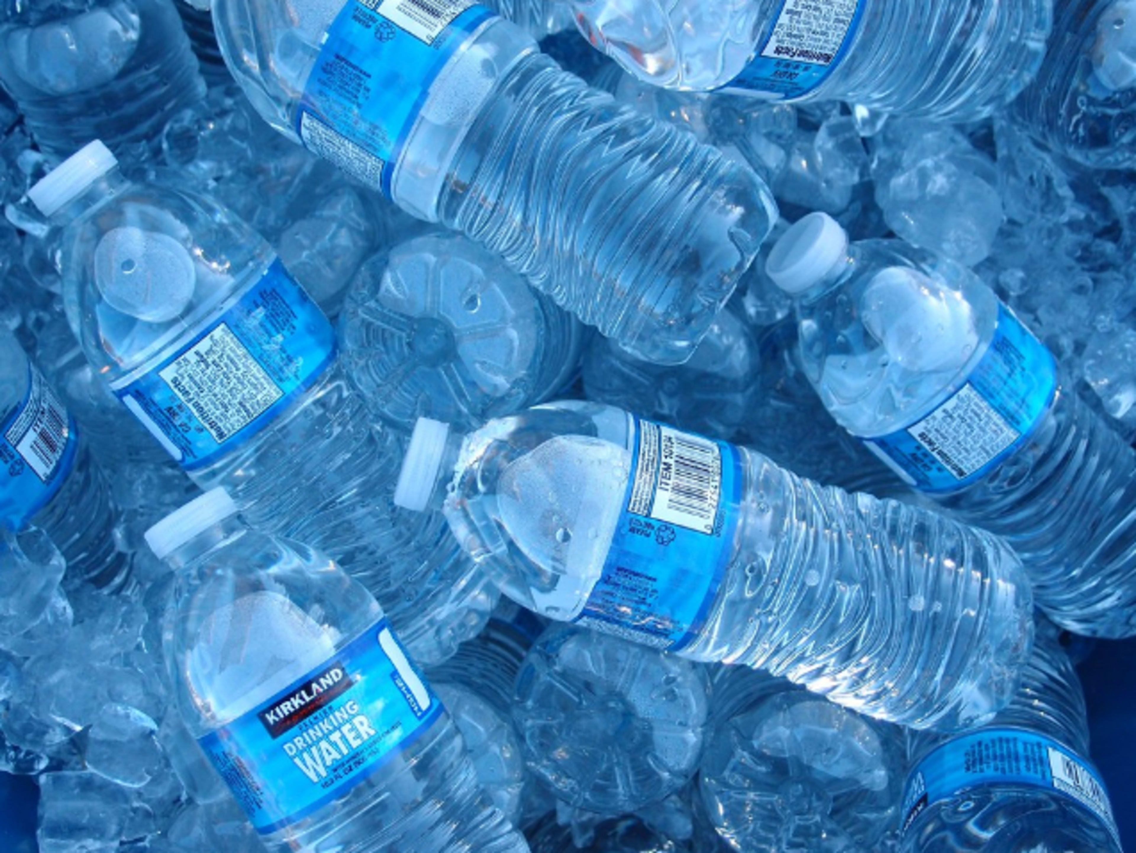 Bottled water in an iced down cooler. 