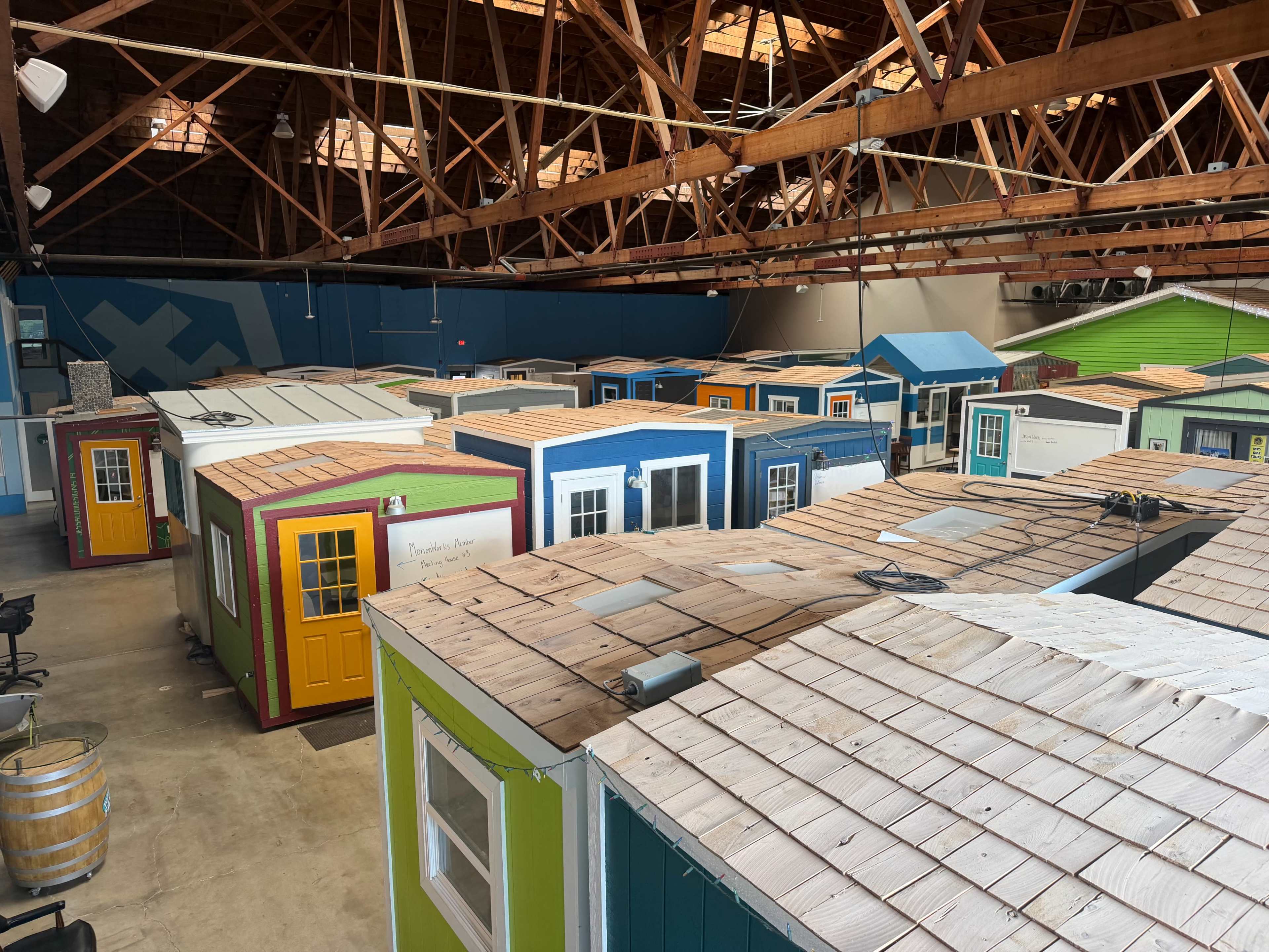 The image shows a large indoor space filled with multiple small, colorful houses arranged closely together.