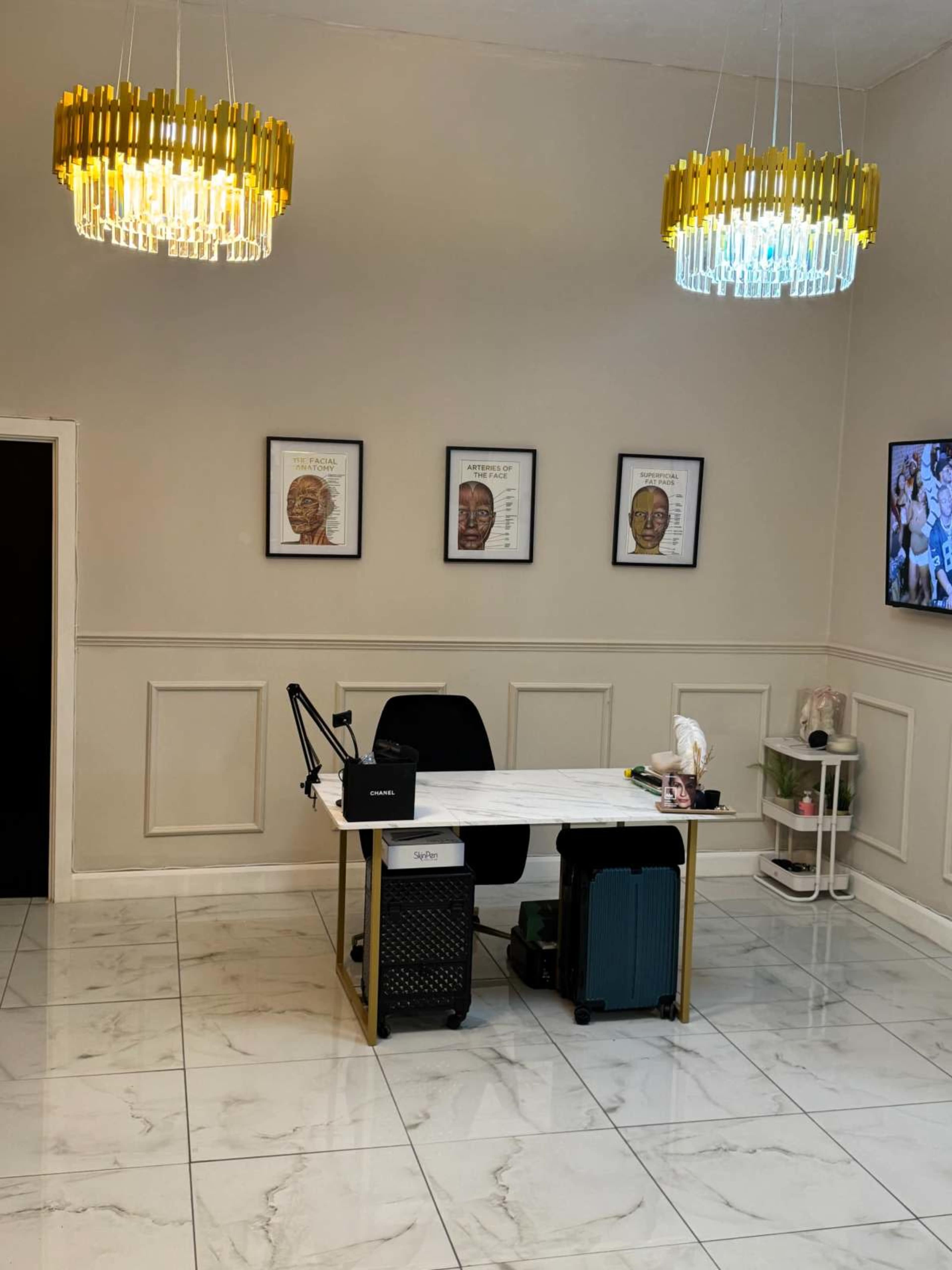 The image shows a modern office space with a marble floor, a desk with a chair, and decorative lighting fixtures above.