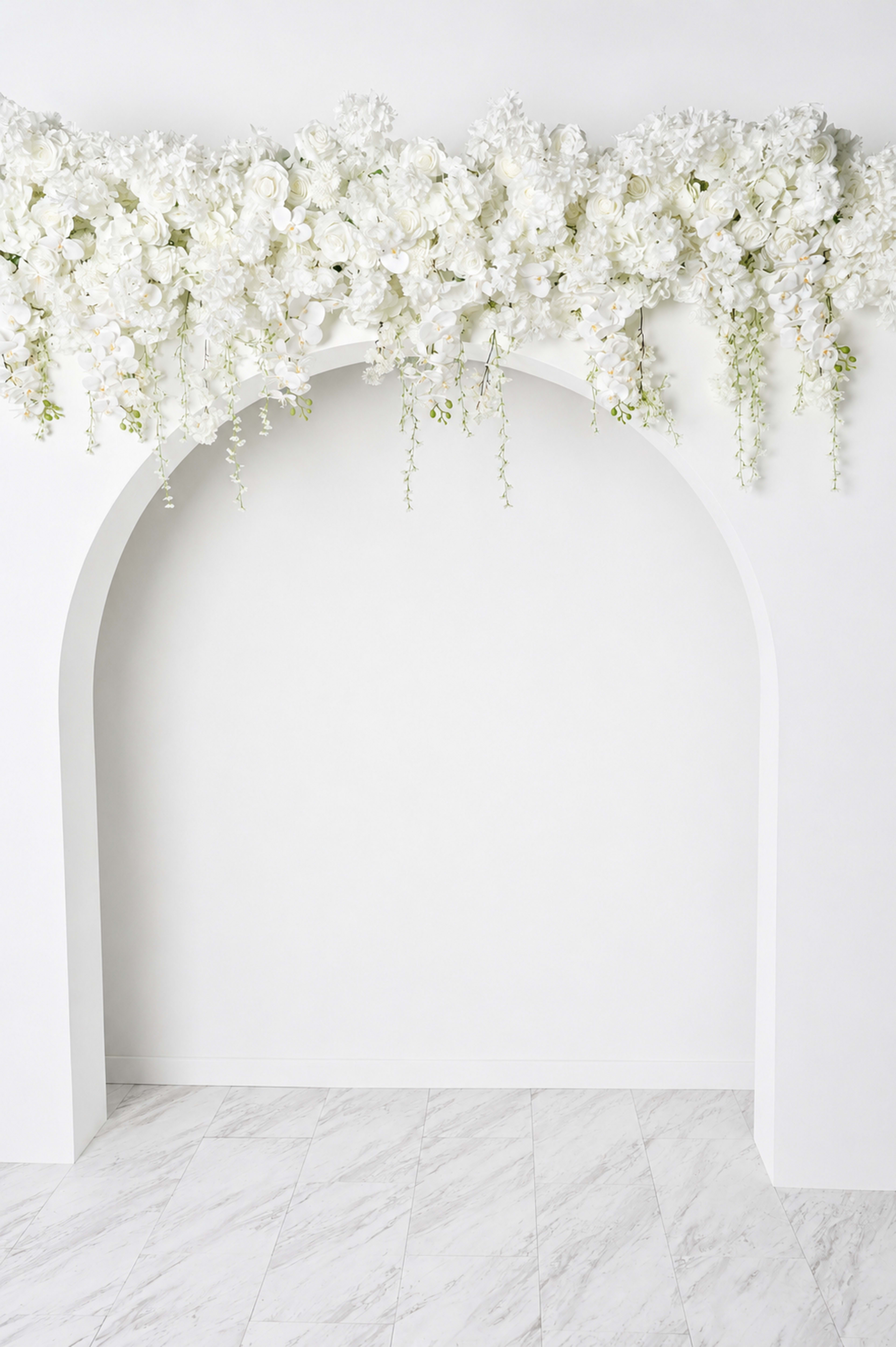 The image features a white arch adorned with a floral arrangement at the top, set against a plain white wall and marble floor.