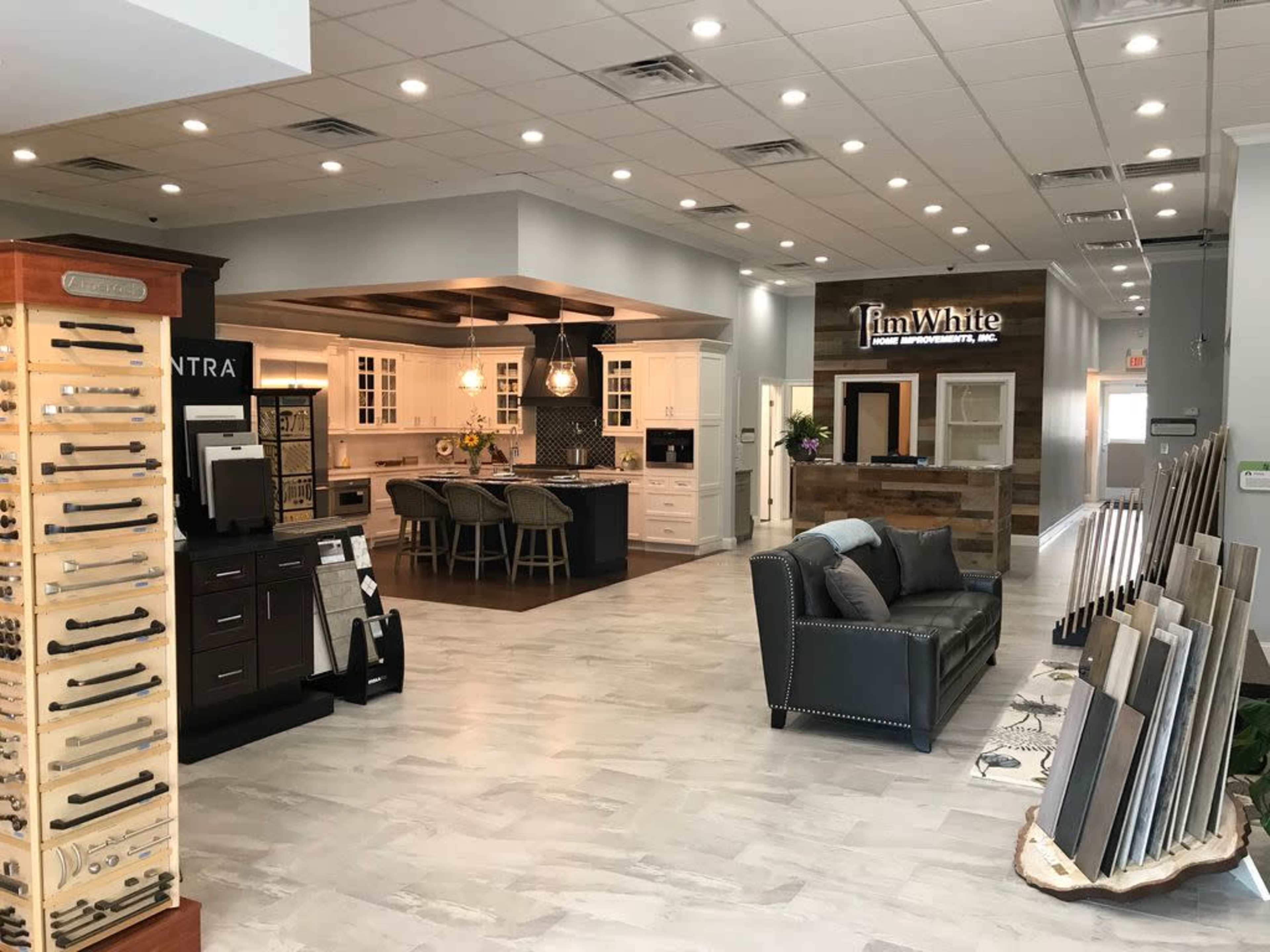 A modern kitchen and cabinetry showroom featuring various displays of kitchen fixtures and materials.