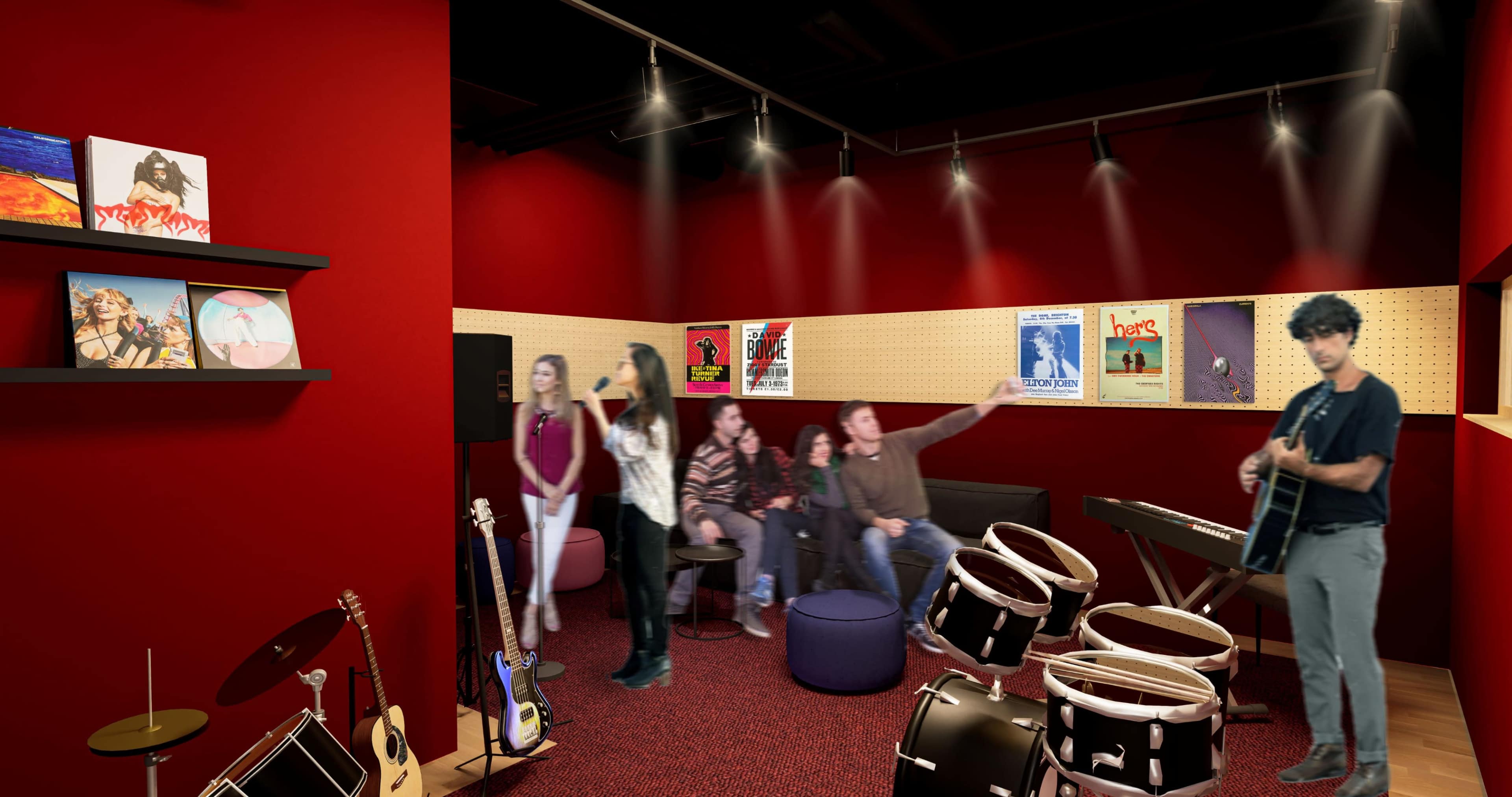 A group of people is gathered in a red-walled room with musical instruments, including drums and a keyboard, while one person is playing guitar.