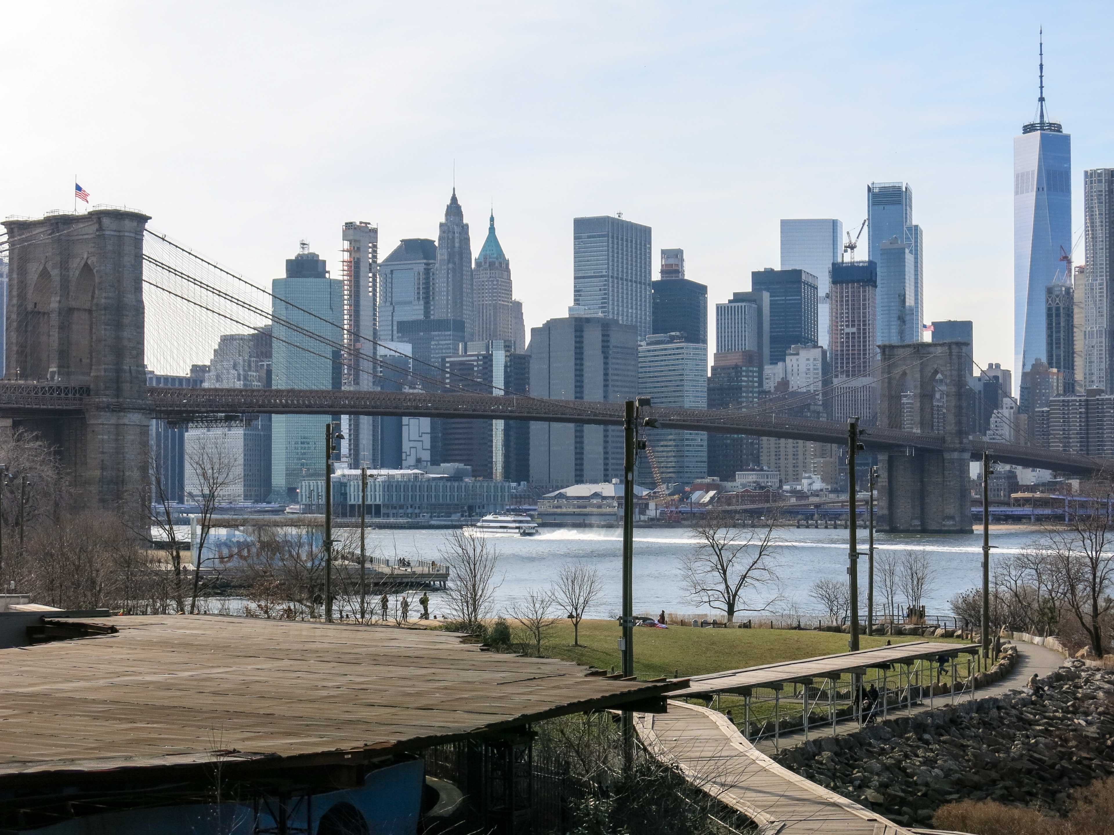 The Brooklyn Bridge spanning the East River with the Manhattan skyline in the background.