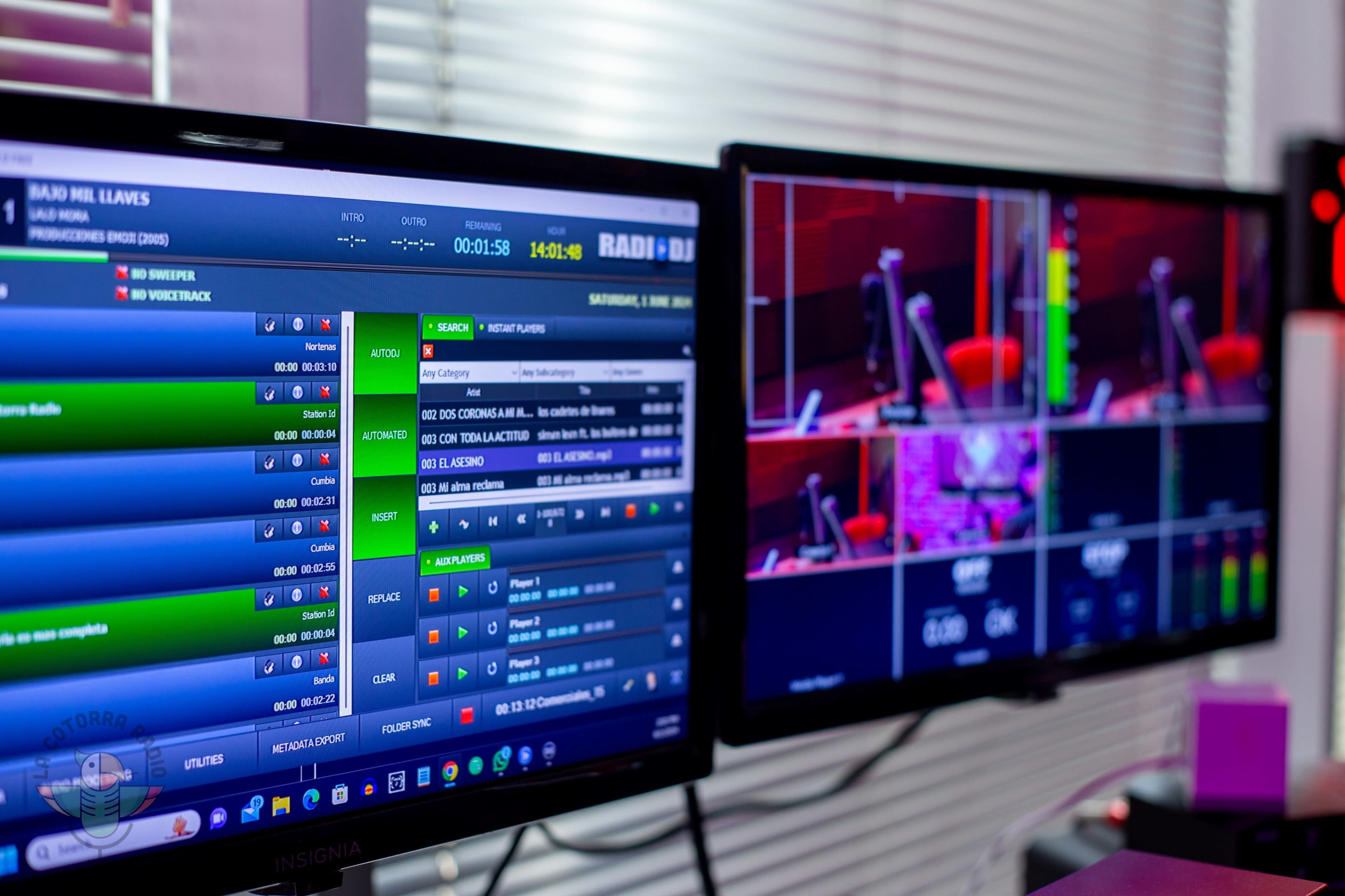 A broadcasting studio with two monitors displaying software interfaces for audio and video production, alongside camera feeds and controls.