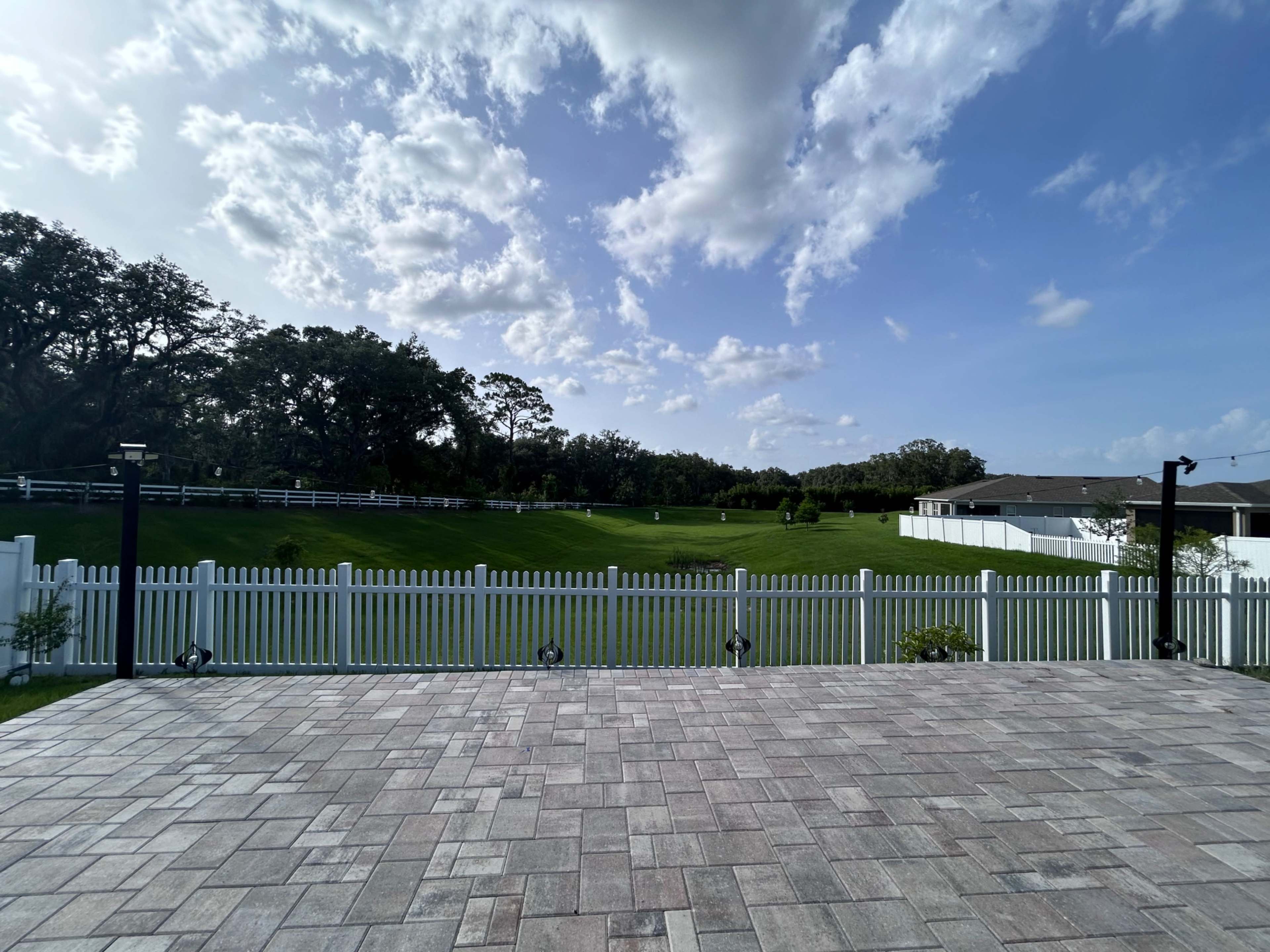 Charming Outdoor Photography Space with Greenery + White Picket Fence Backdrop Image in Leesburg, Okhumpka, FL