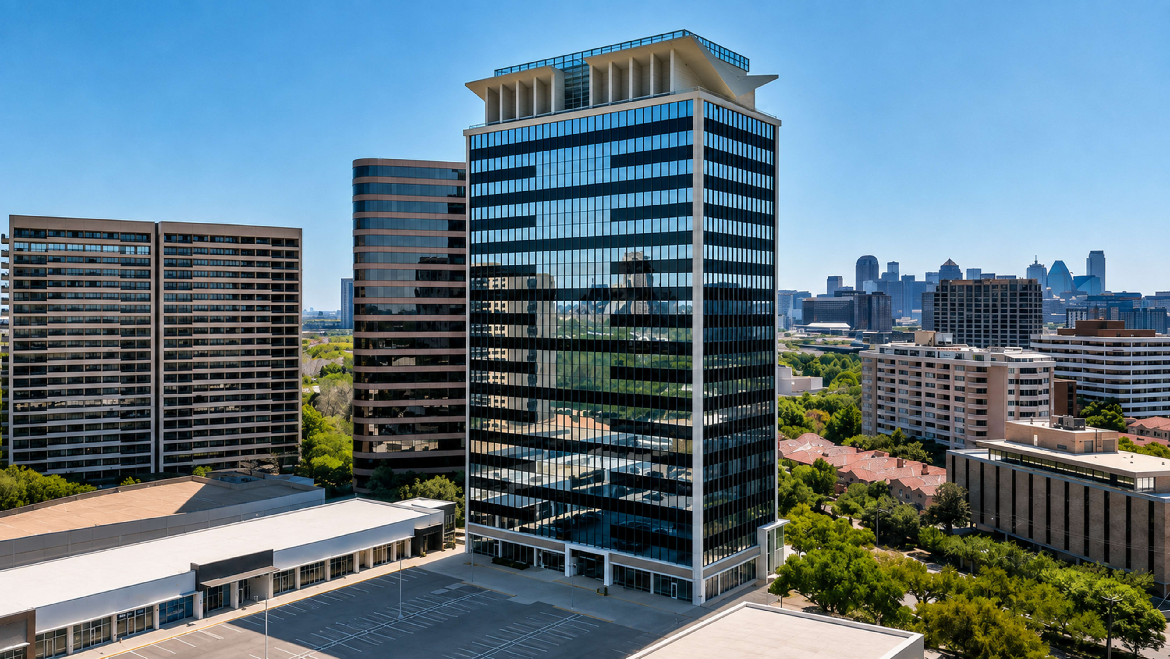 The image shows a modern high-rise building with reflective glass façades, surrounded by other skyscrapers and greenery, set against a clear blue sky.