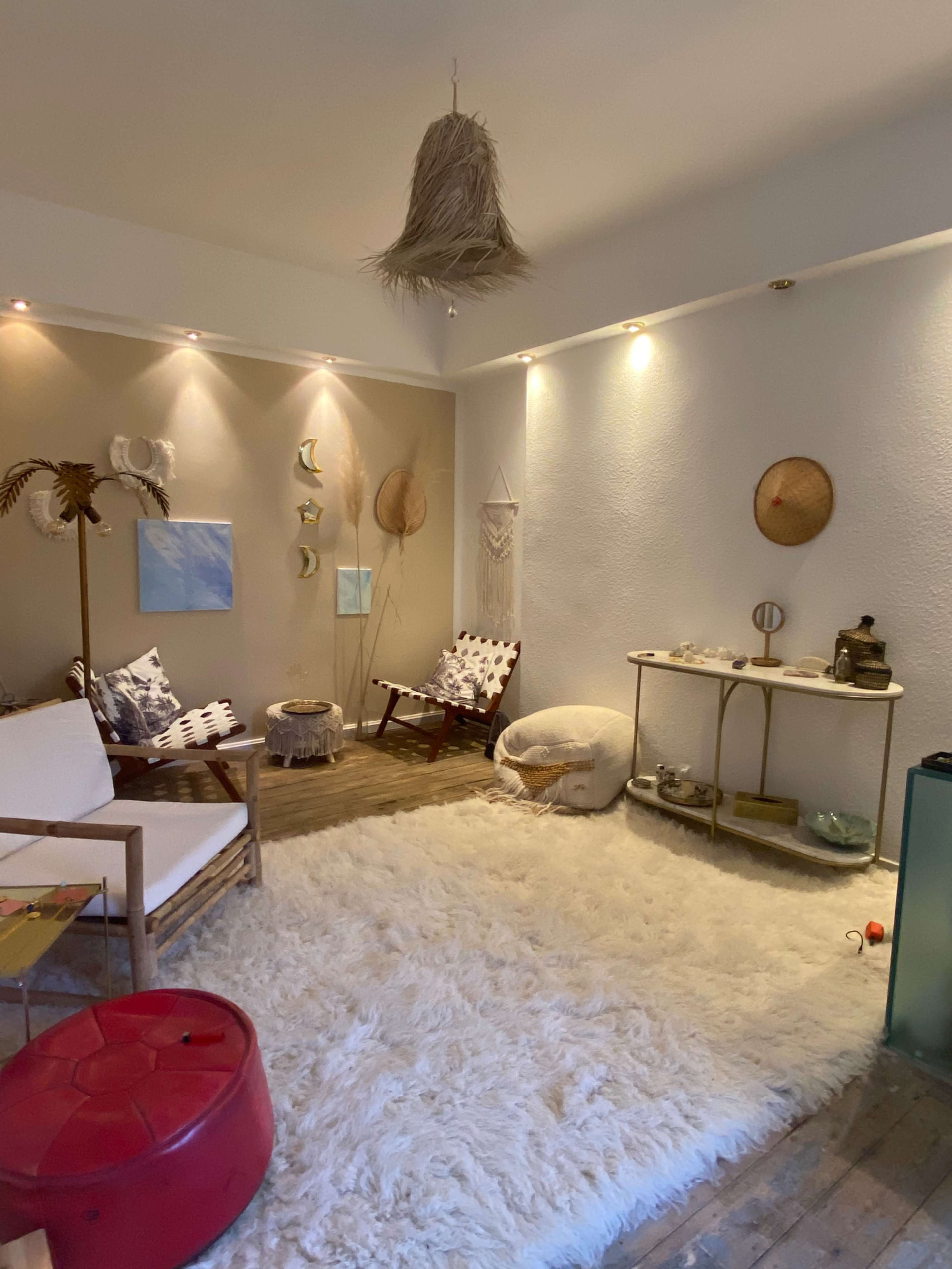 The room features a cozy seating area with a rug, soft lighting, and decorative wall art.