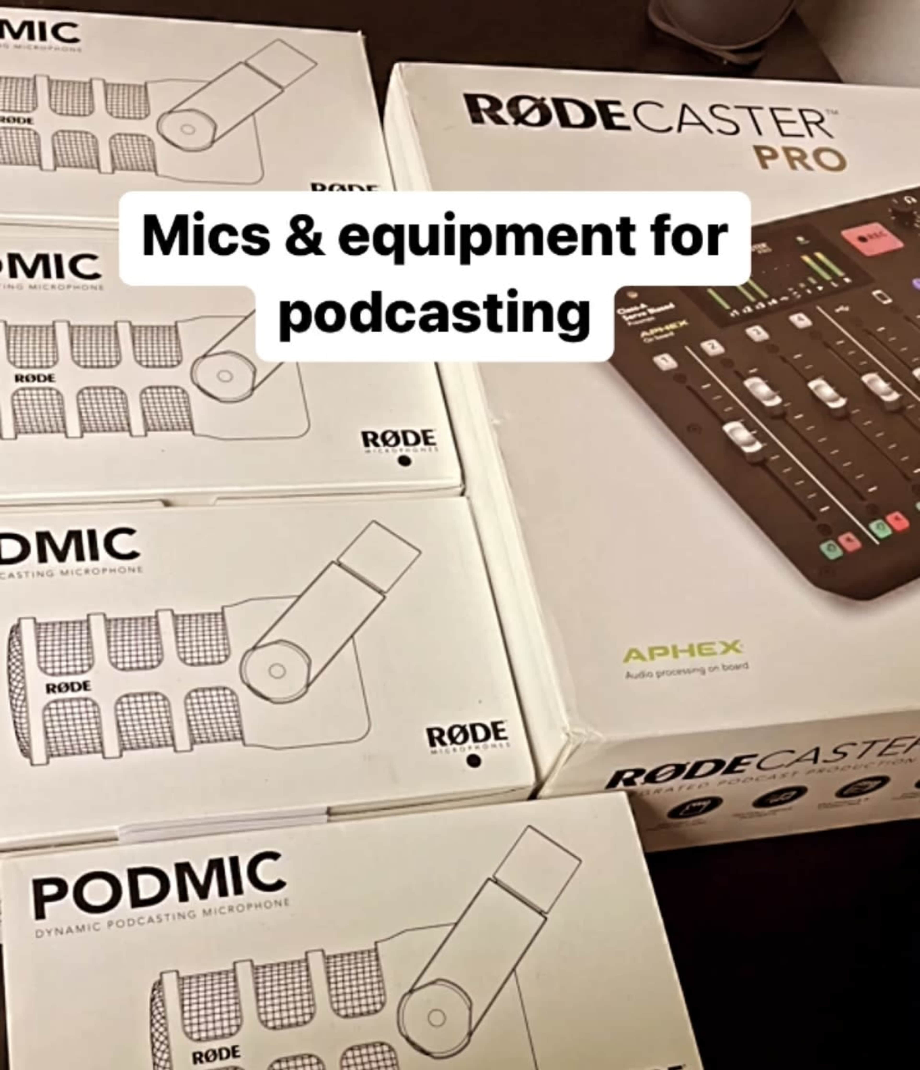 A Rodecaster Pro audio interface alongside several boxes of Rode Podmic podcasting microphones.